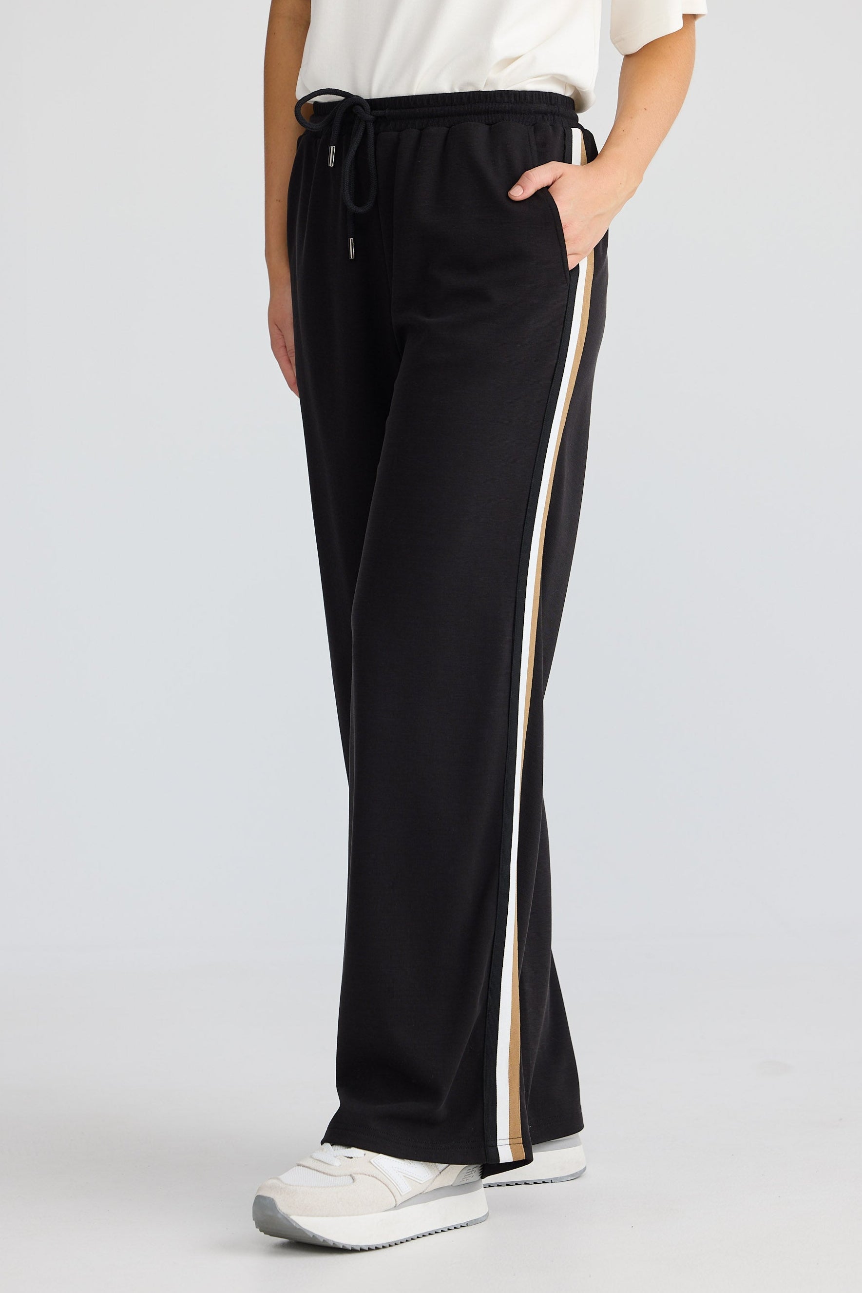 Black pants with a white stripe on a white background