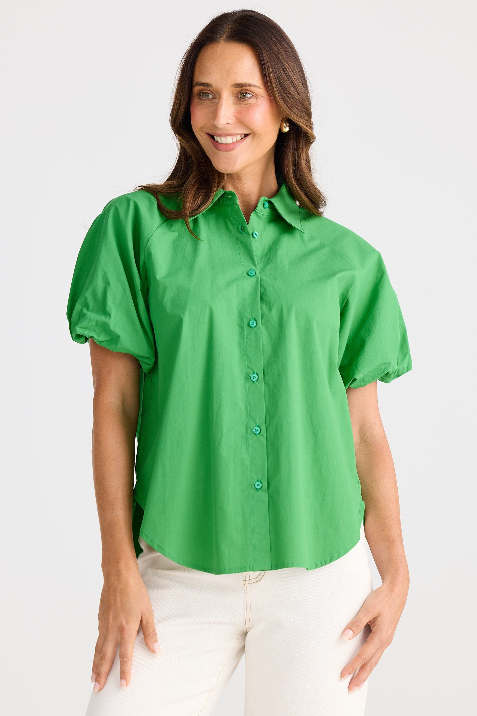 Woman wearing a green blouse with short sleeves on a white background