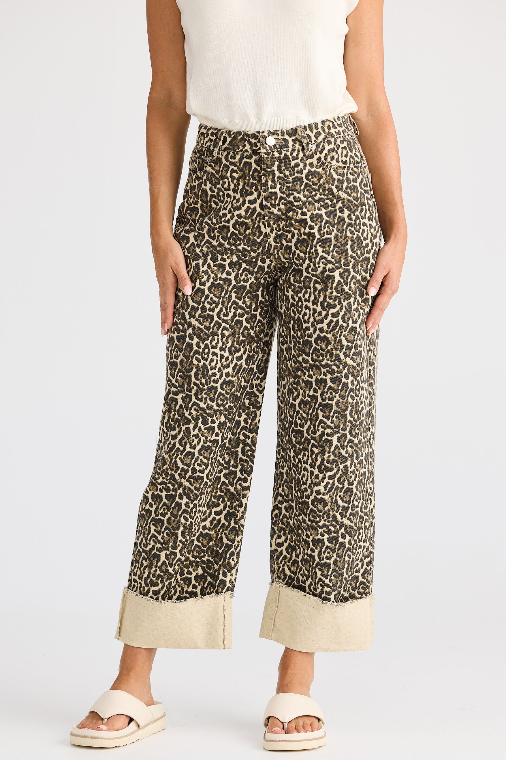 Leopard print pants worn by a person on a white background