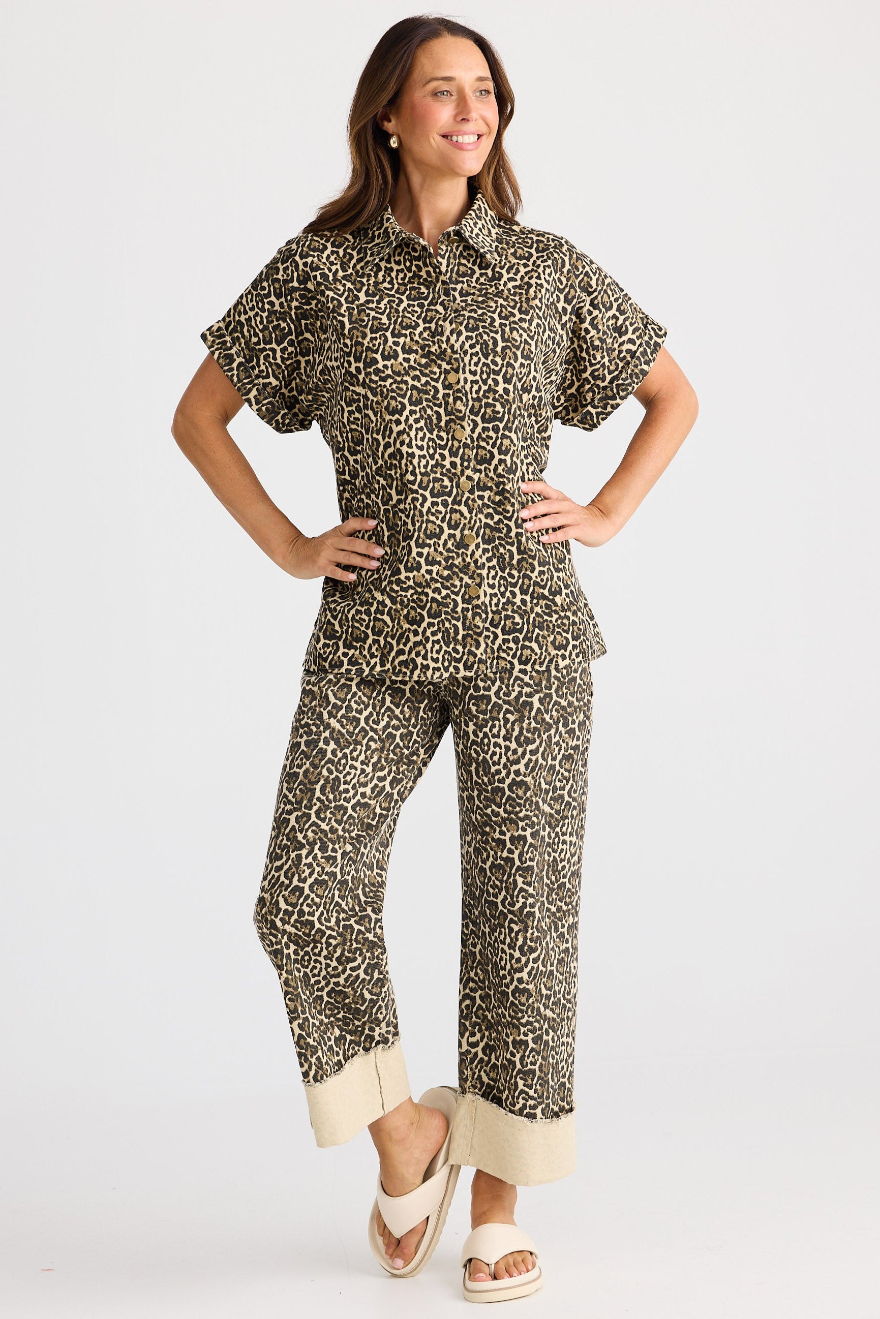 Woman wearing a patterned outfit on a white background