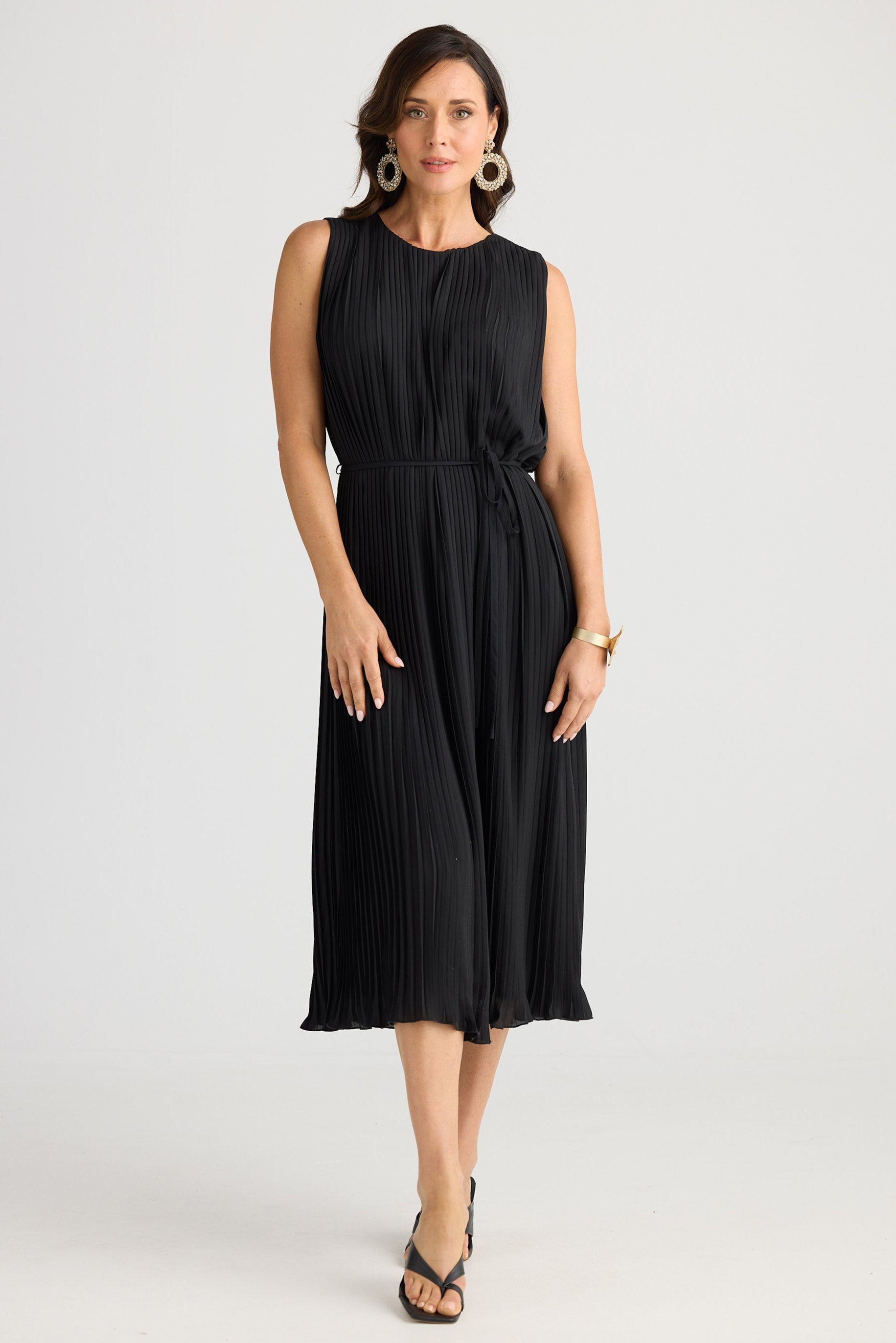 Woman wearing a black sleeveless dress on a white background
