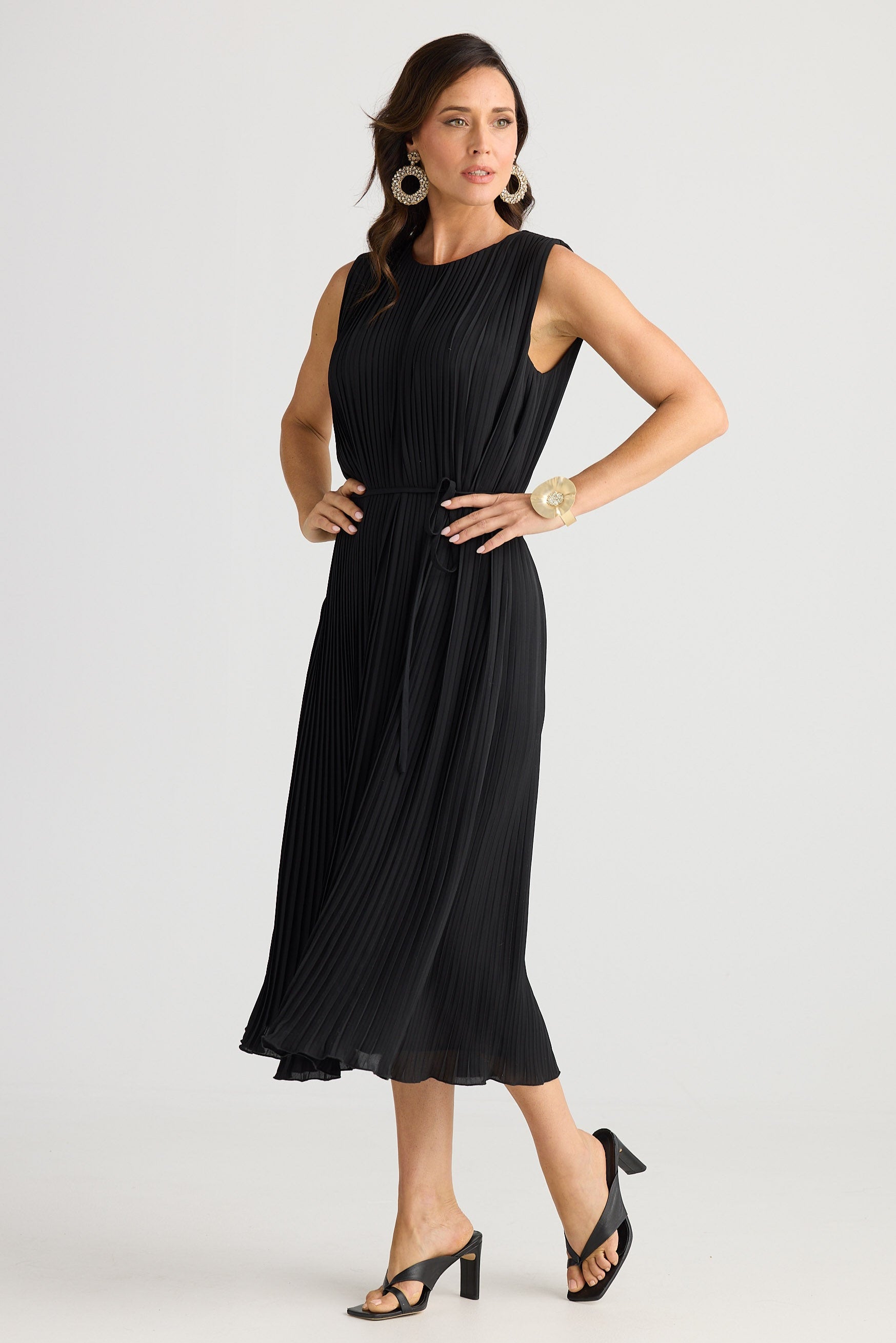 Woman wearing a black sleeveless dress on a white background