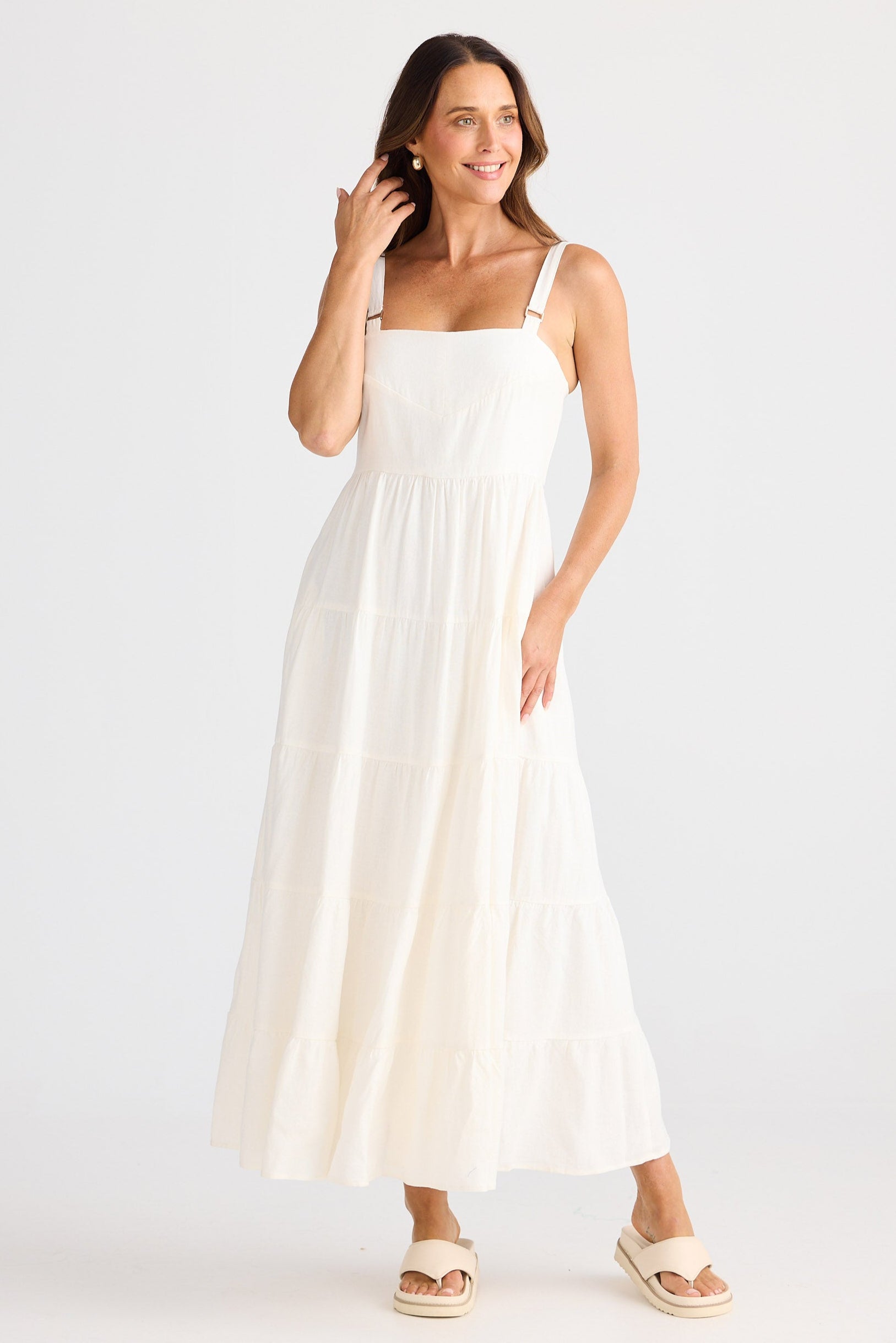 Woman wearing a white dress on a plain background