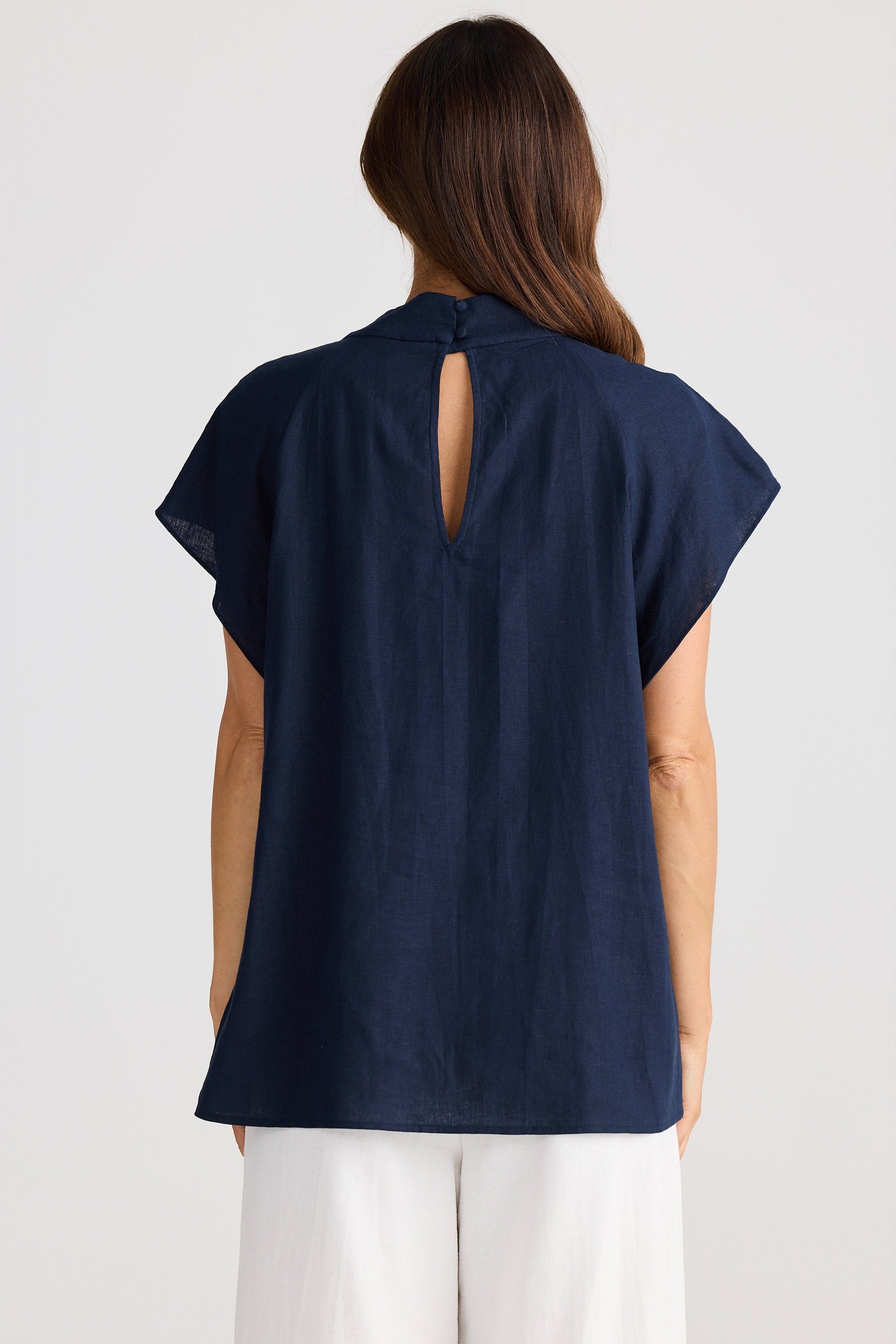 Navy blue sleeveless top with cutout back on a white background