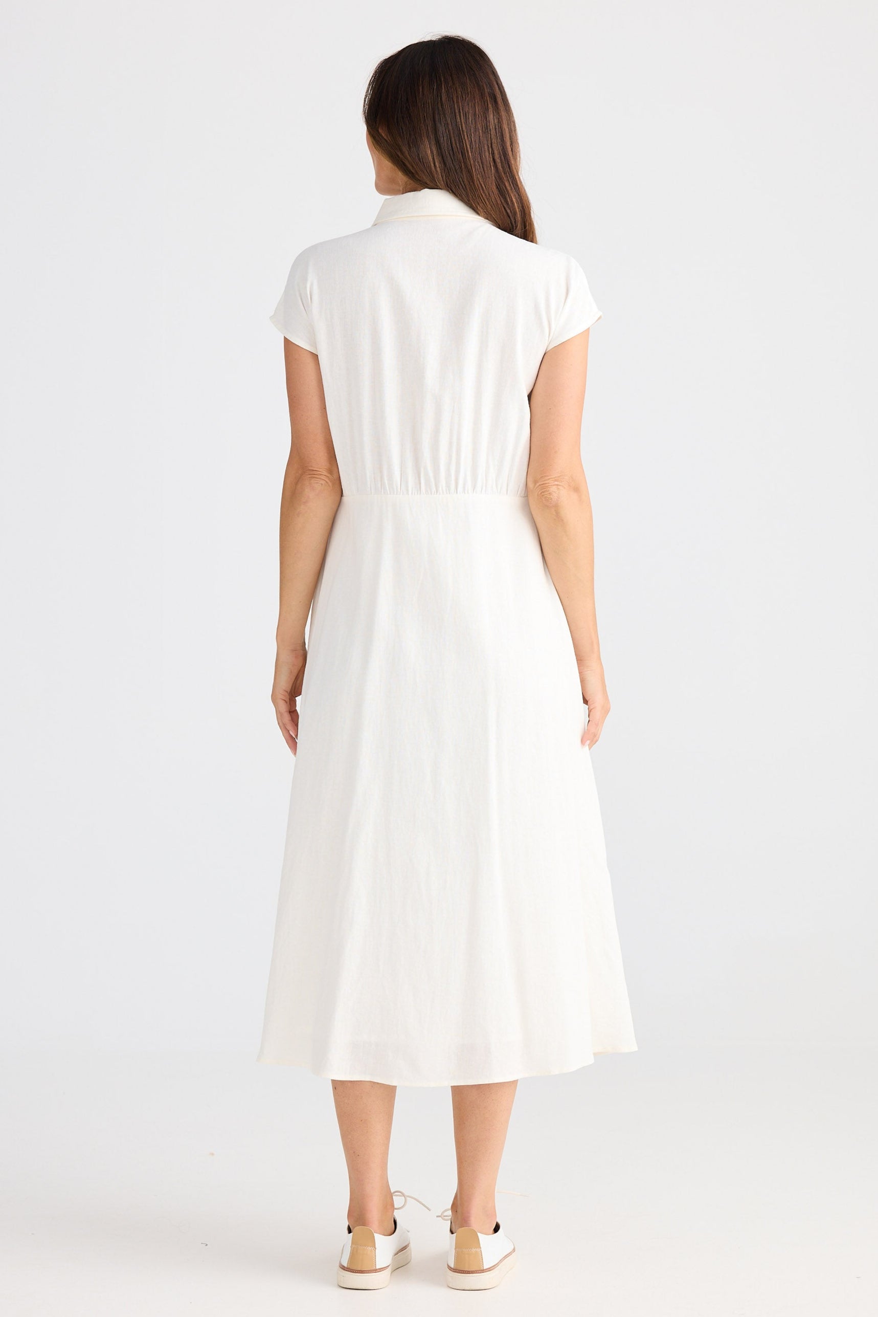 Woman wearing a white dress on a white background