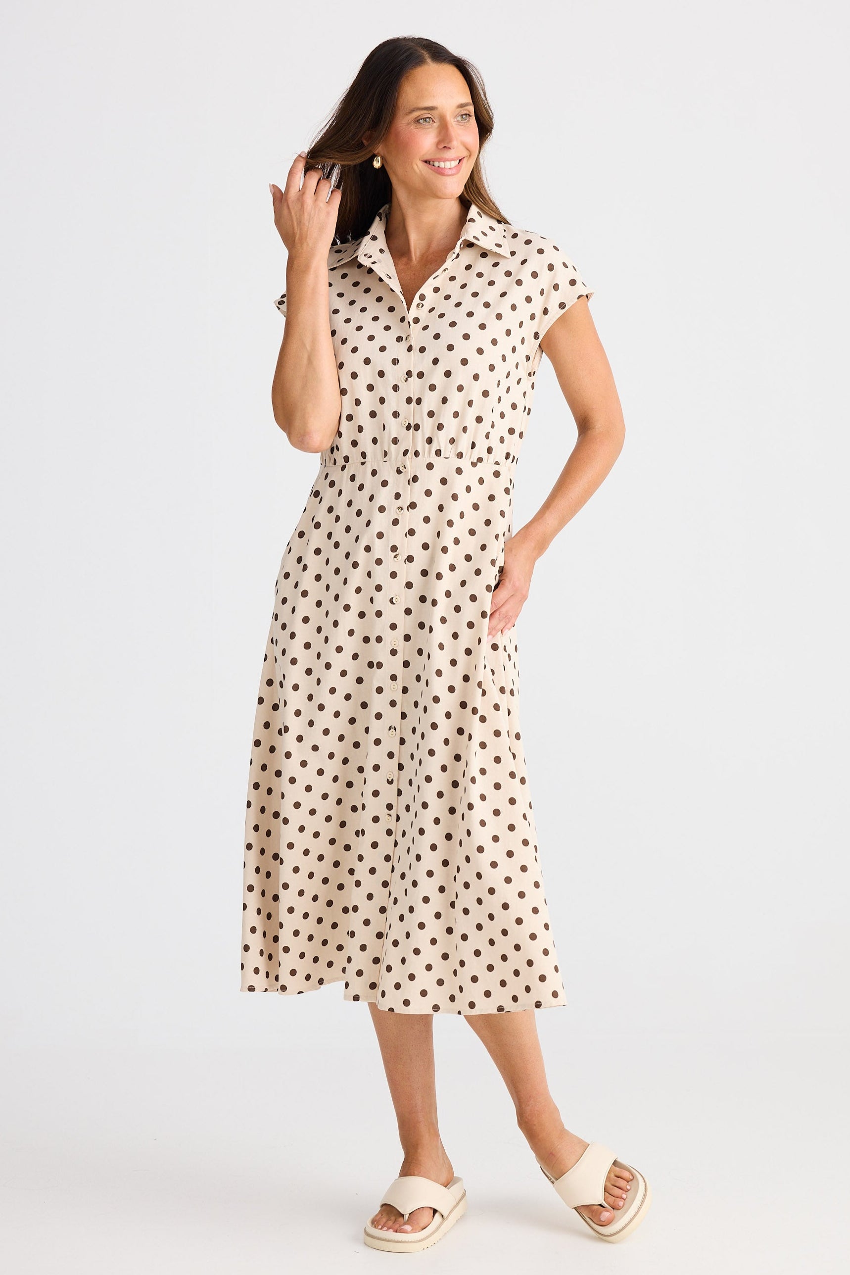 Woman wearing a polka dot dress on a white background