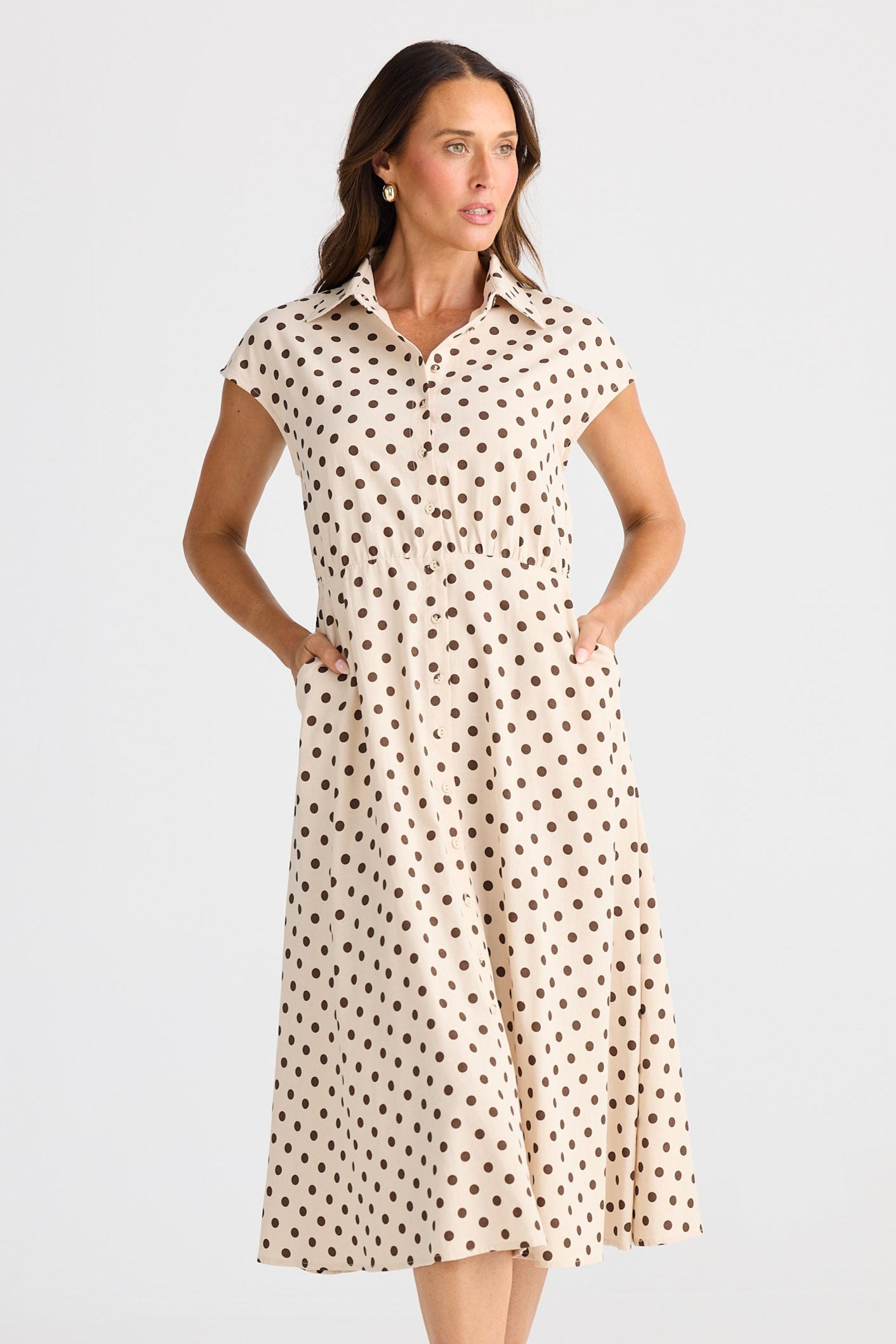Woman wearing a polka dot dress on a white background