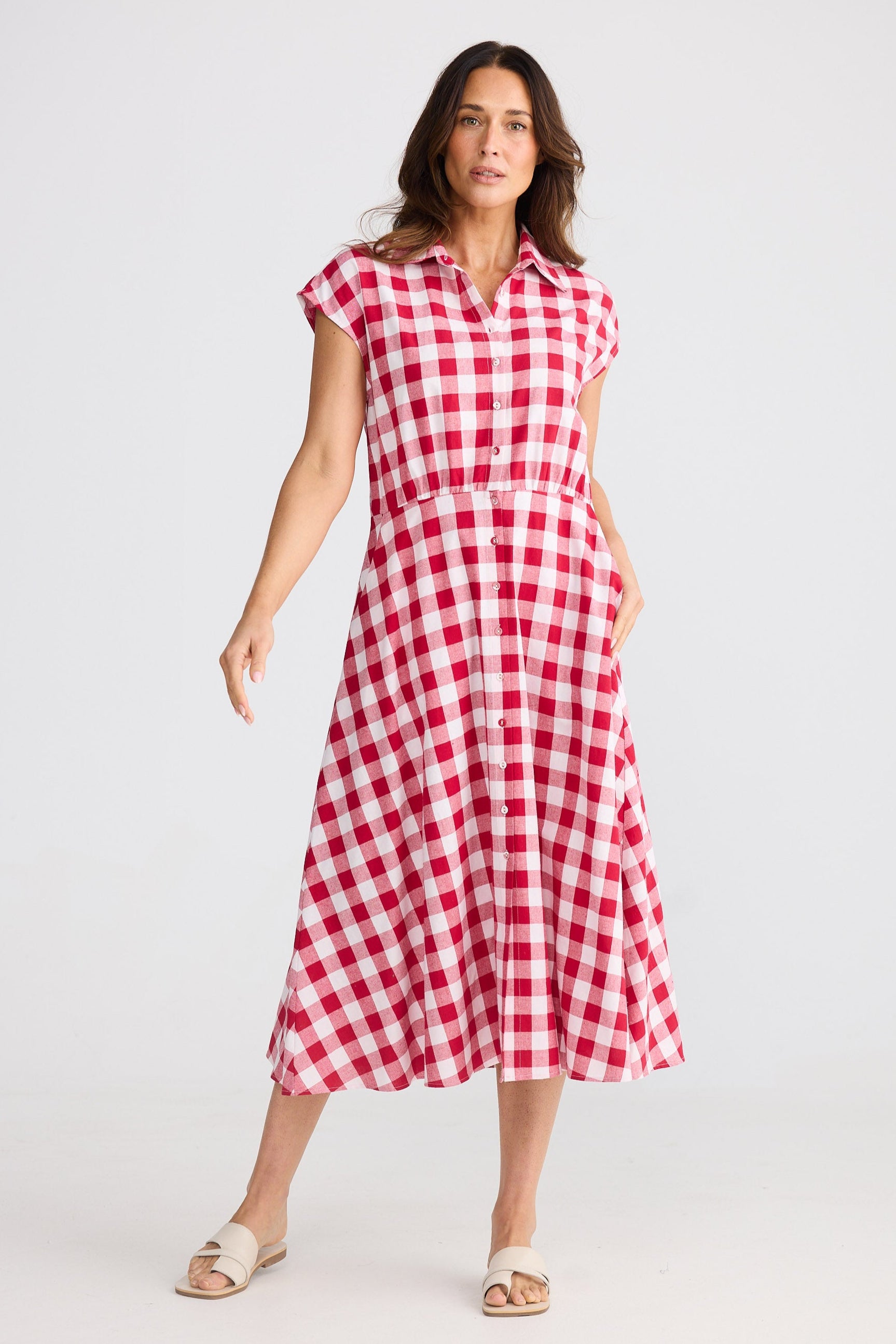 Woman wearing a red and white checkered dress on a white background