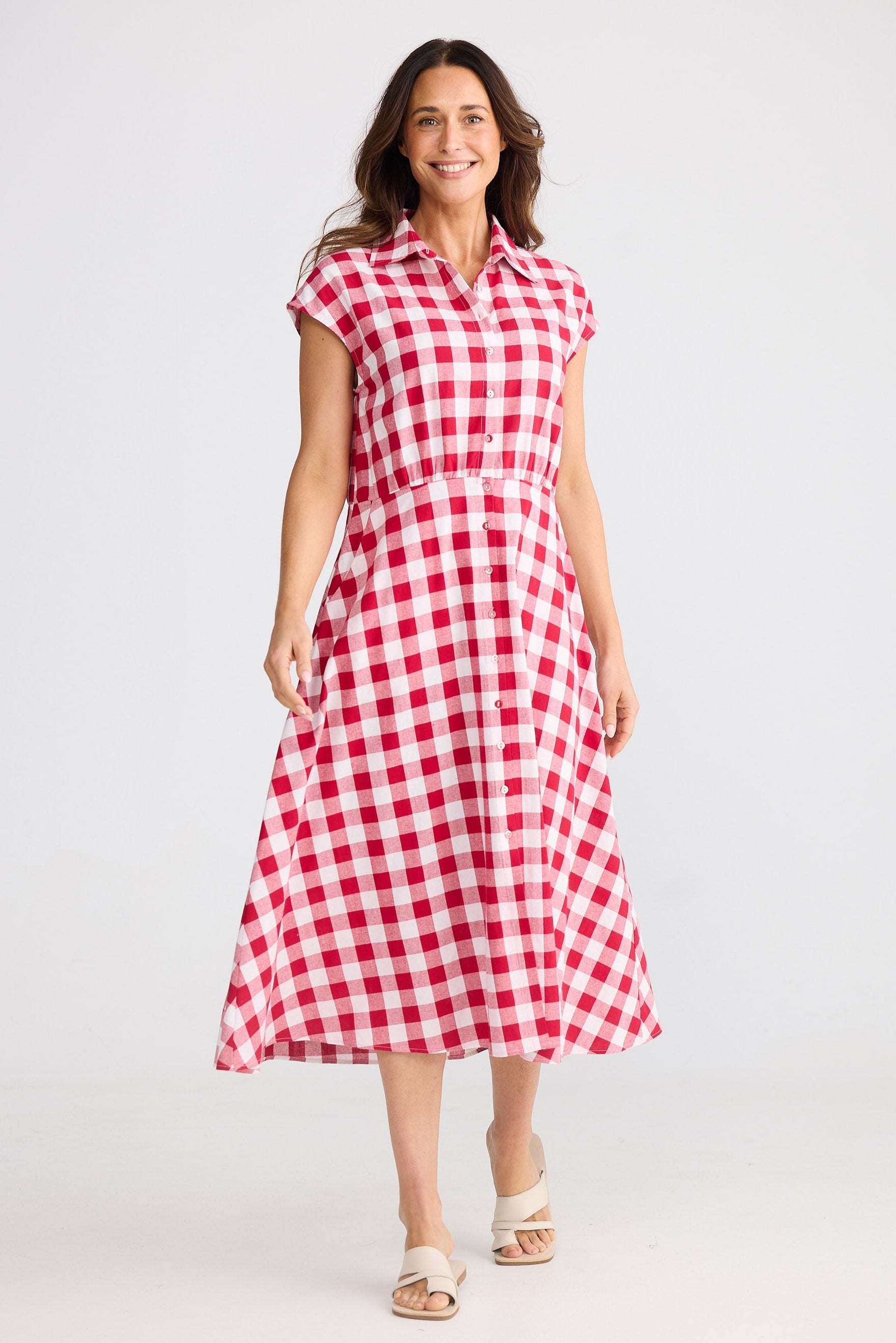Woman wearing a red and white checkered dress on a white background