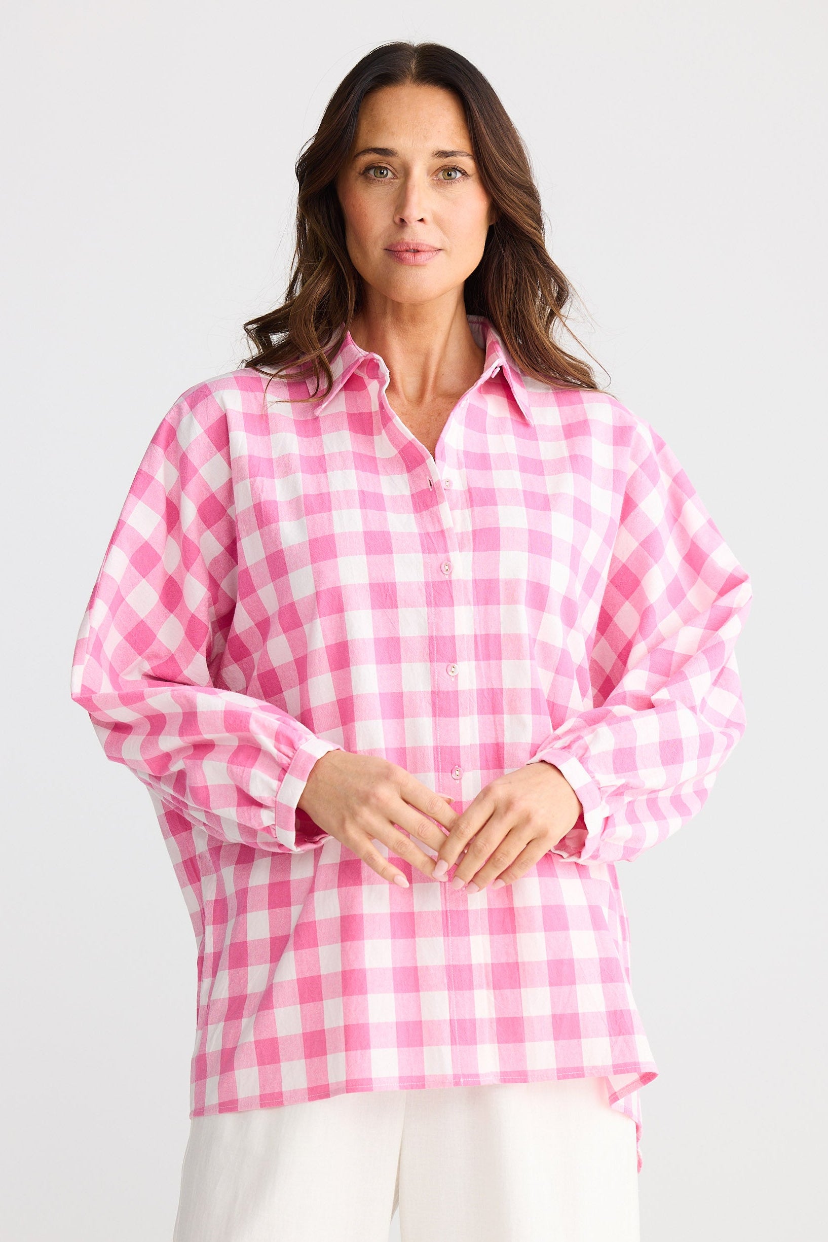 Woman wearing a pink checkered shirt on a white background