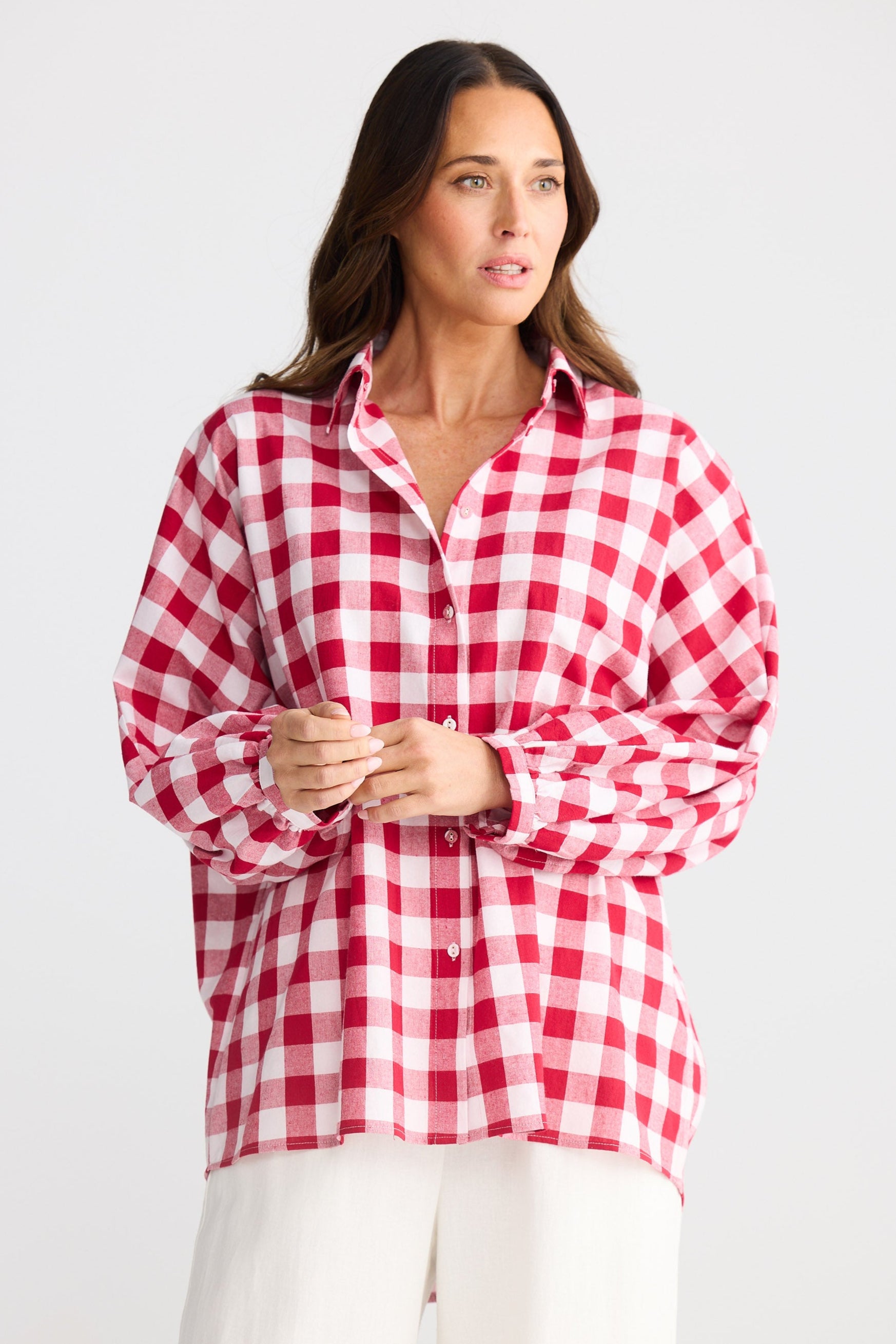 Woman wearing a red and white checkered shirt on a white background