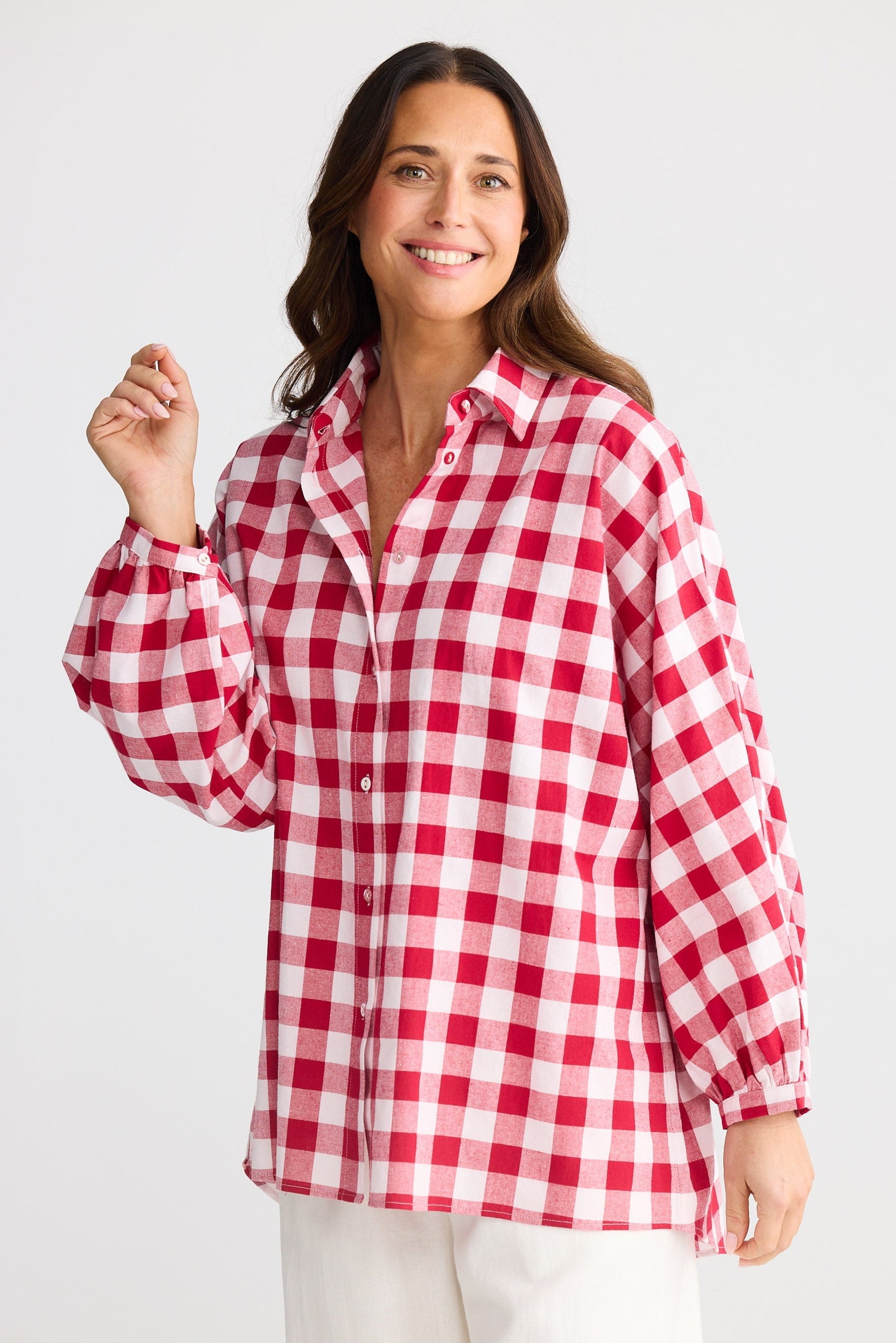 Woman wearing a red and white checkered shirt on a white background
