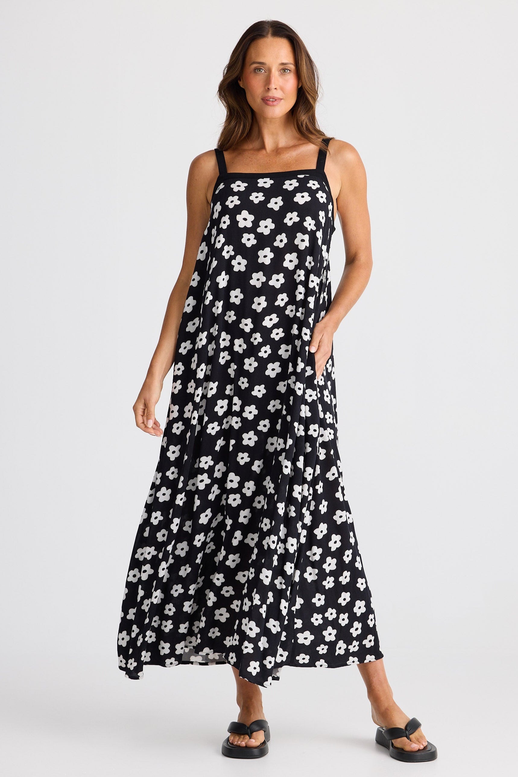 Woman wearing a black floral dress on a white background