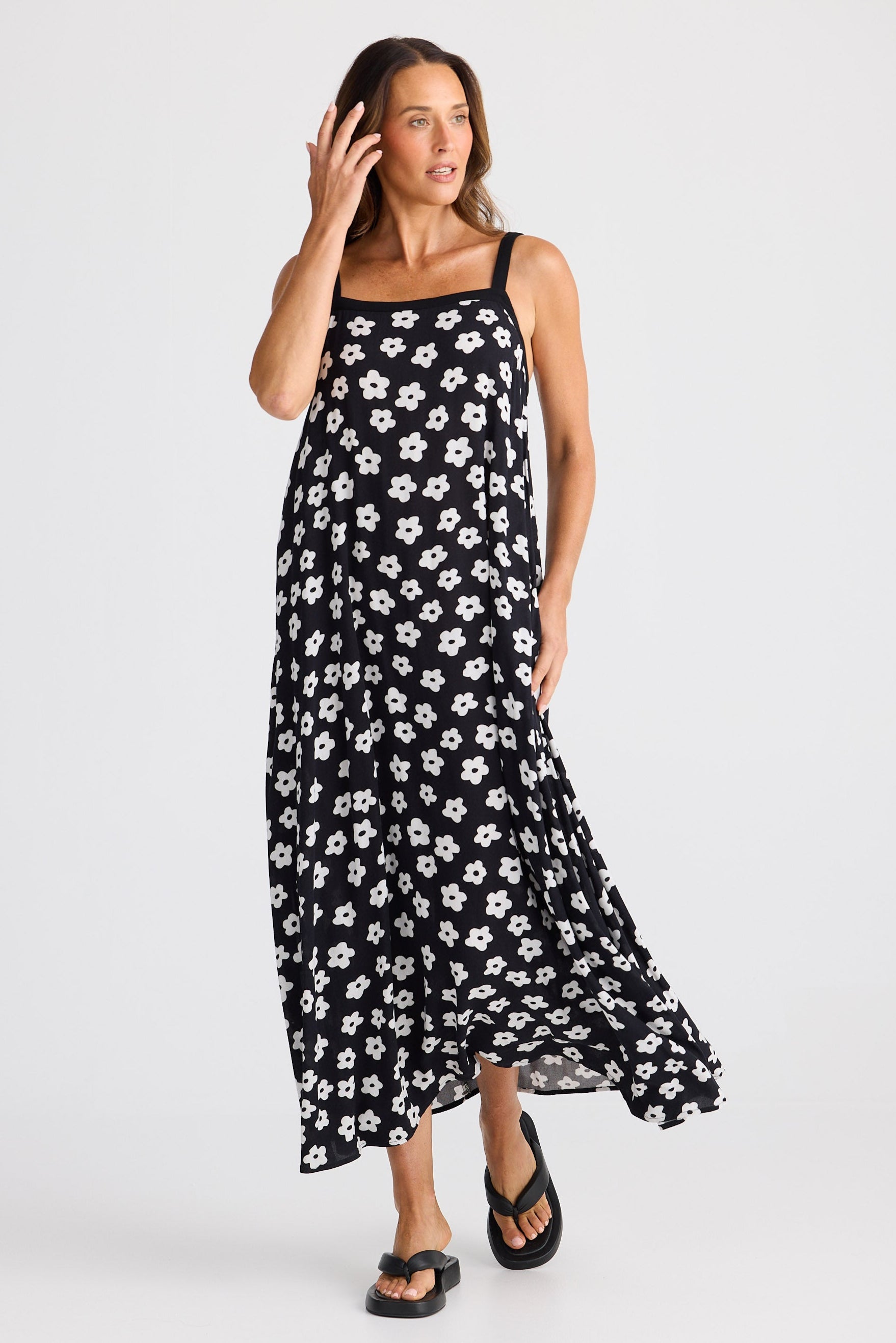 Woman wearing a black floral dress on a white background