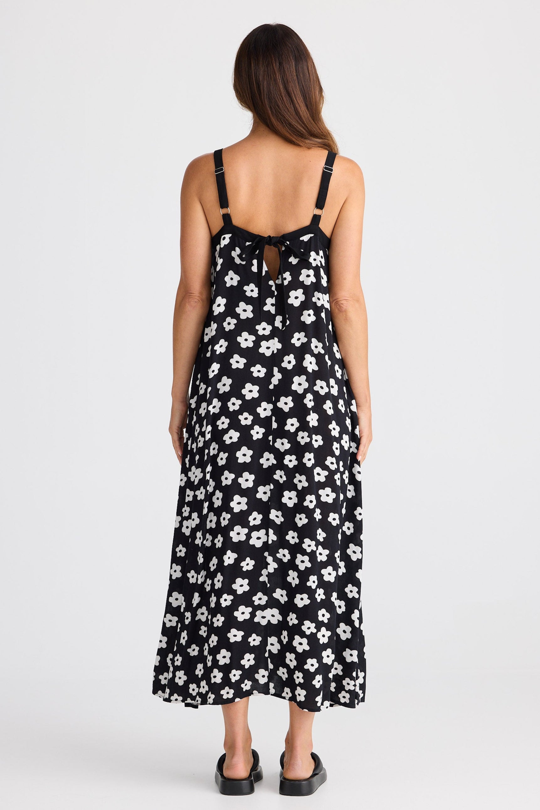 Woman wearing a black floral dress on a white background