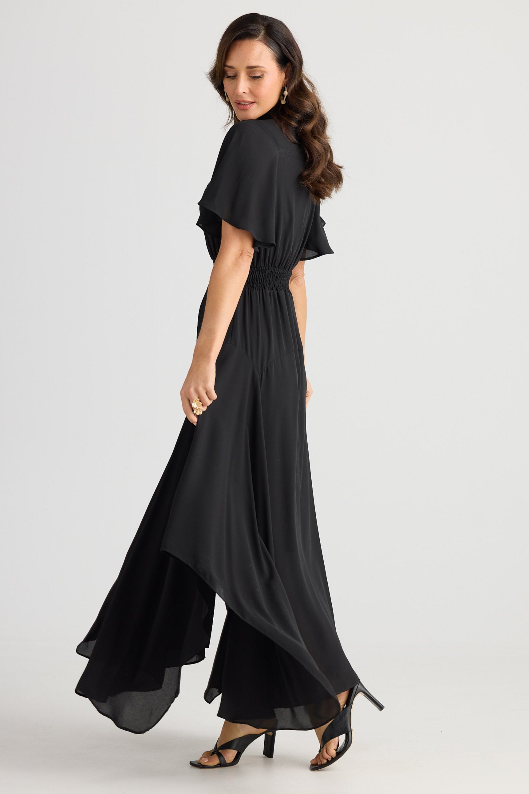 Woman wearing a black dress on a white background