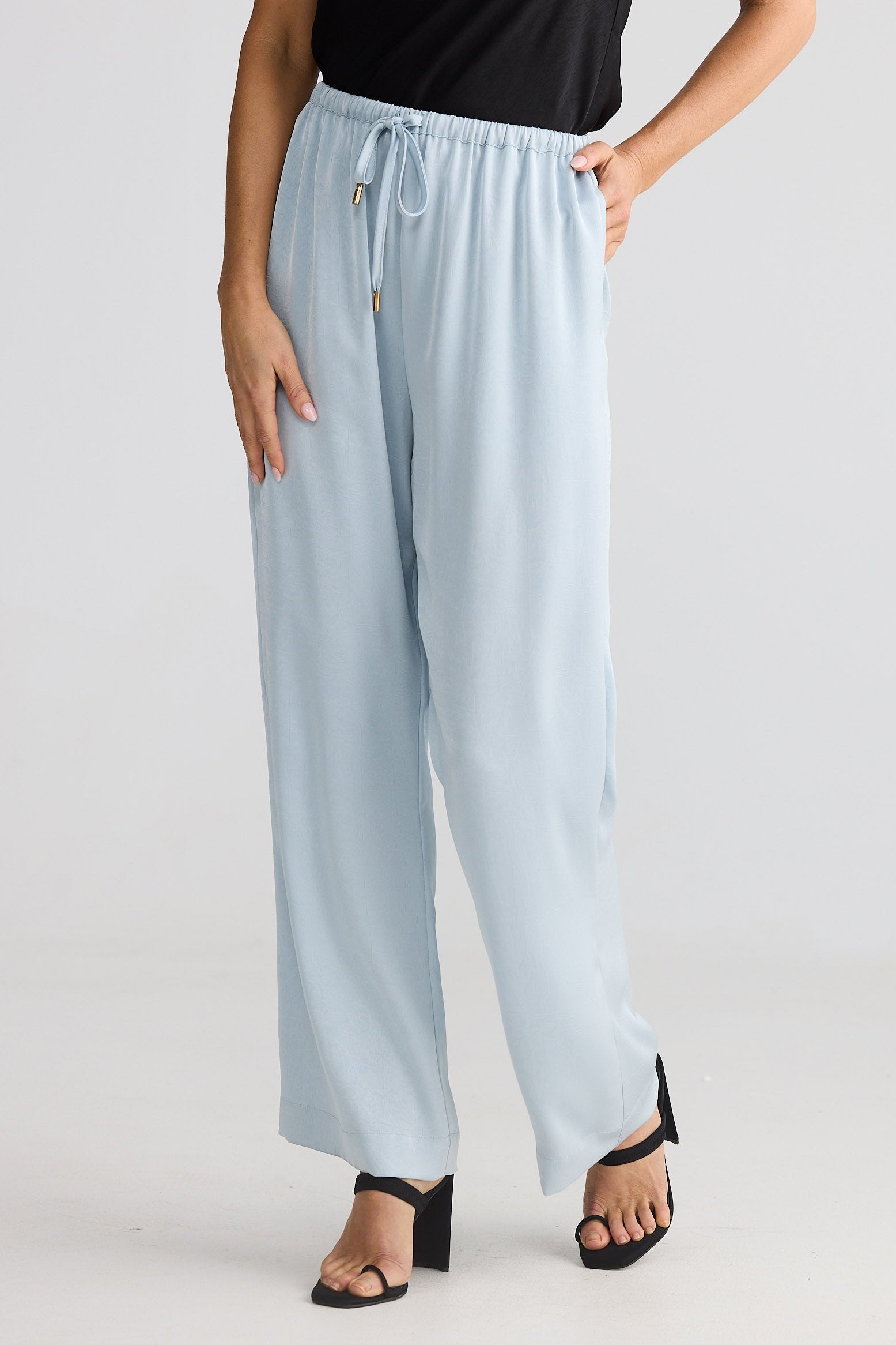 Light blue pants worn by a person on a plain background