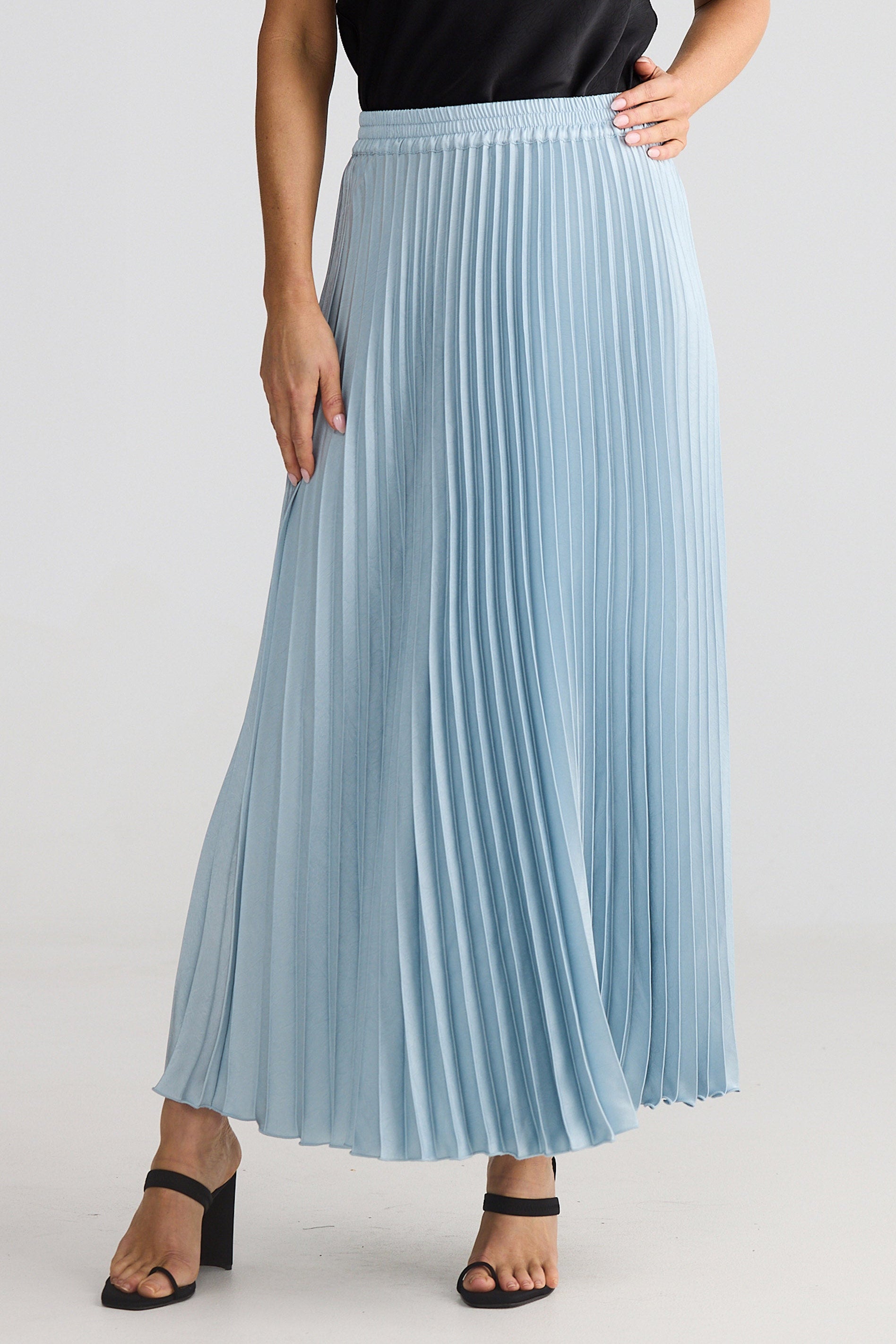 Light blue pleated skirt worn by a person on a plain background