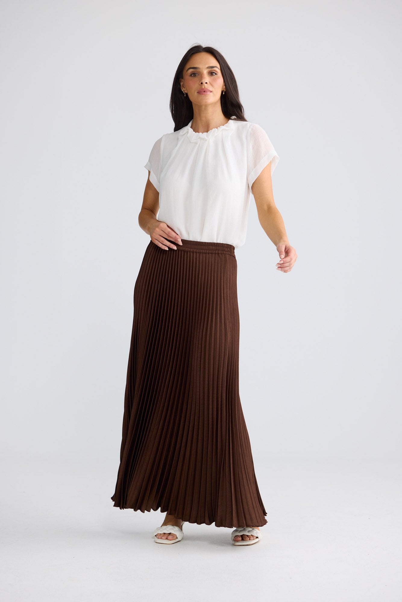 Model wearing Alias Pleated Skirt in Chocolate by Brave + True, view 3.