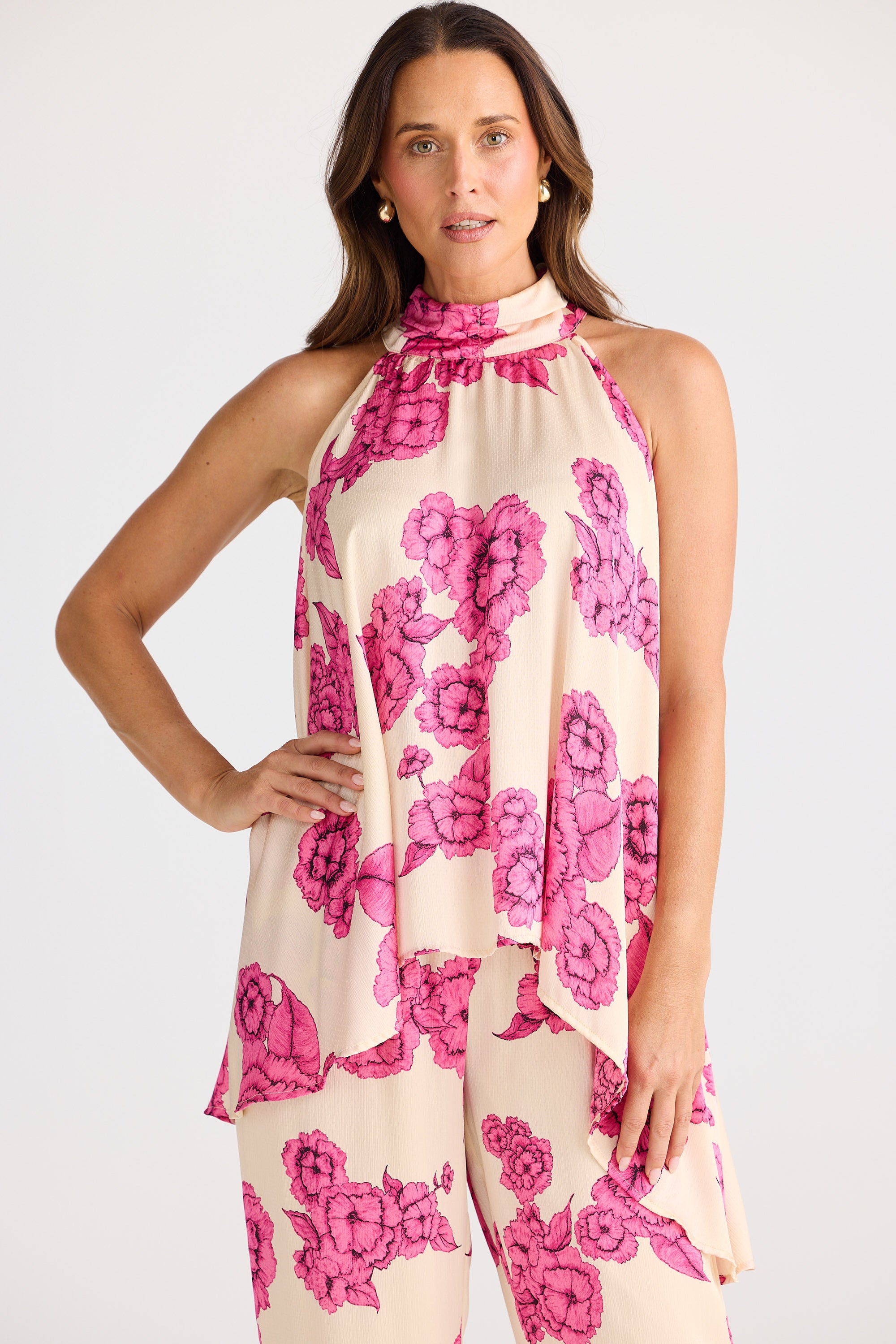 Woman wearing a floral dress with pink flowers on a white background