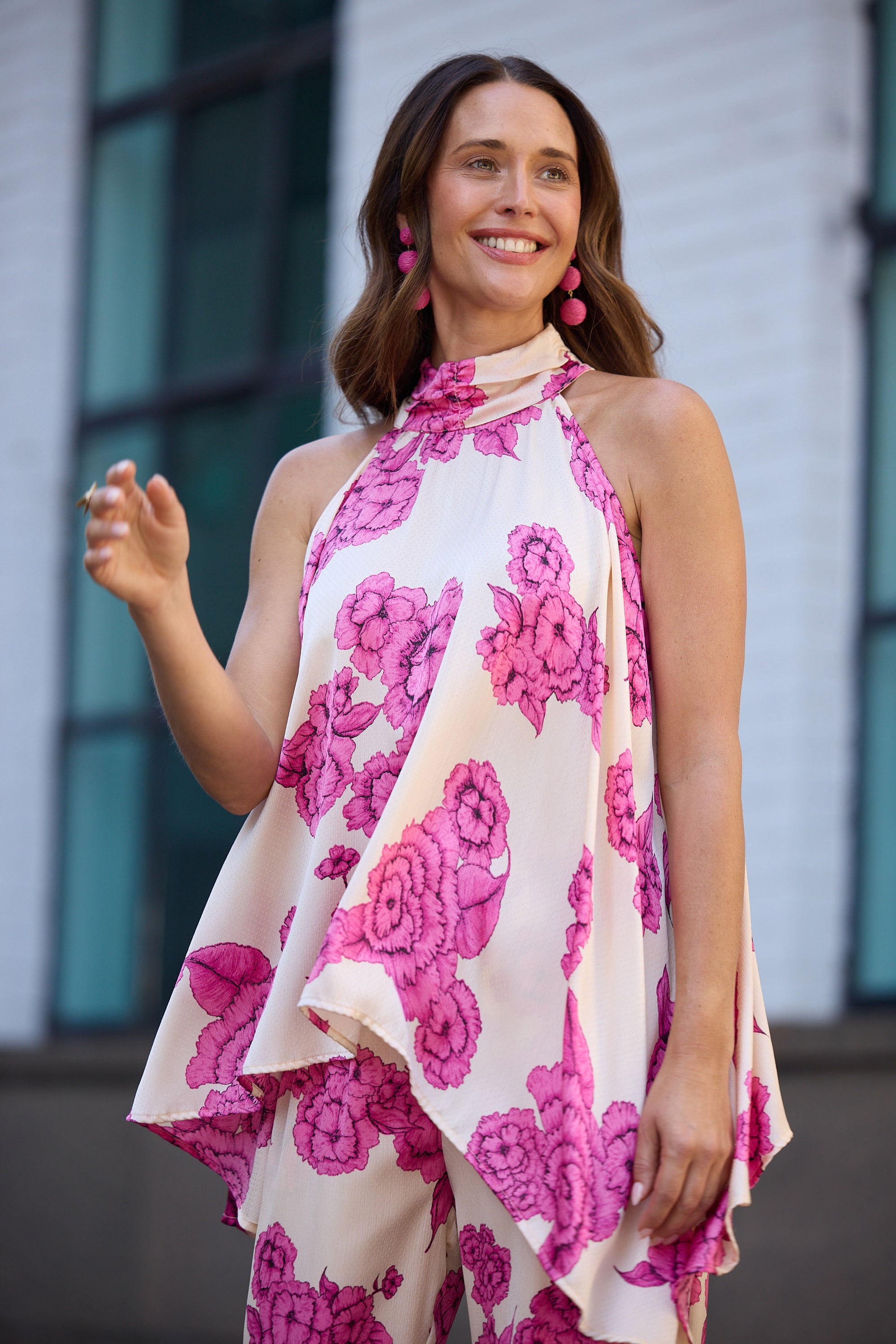 Woman wearing a floral dress with pink flowers on a white background