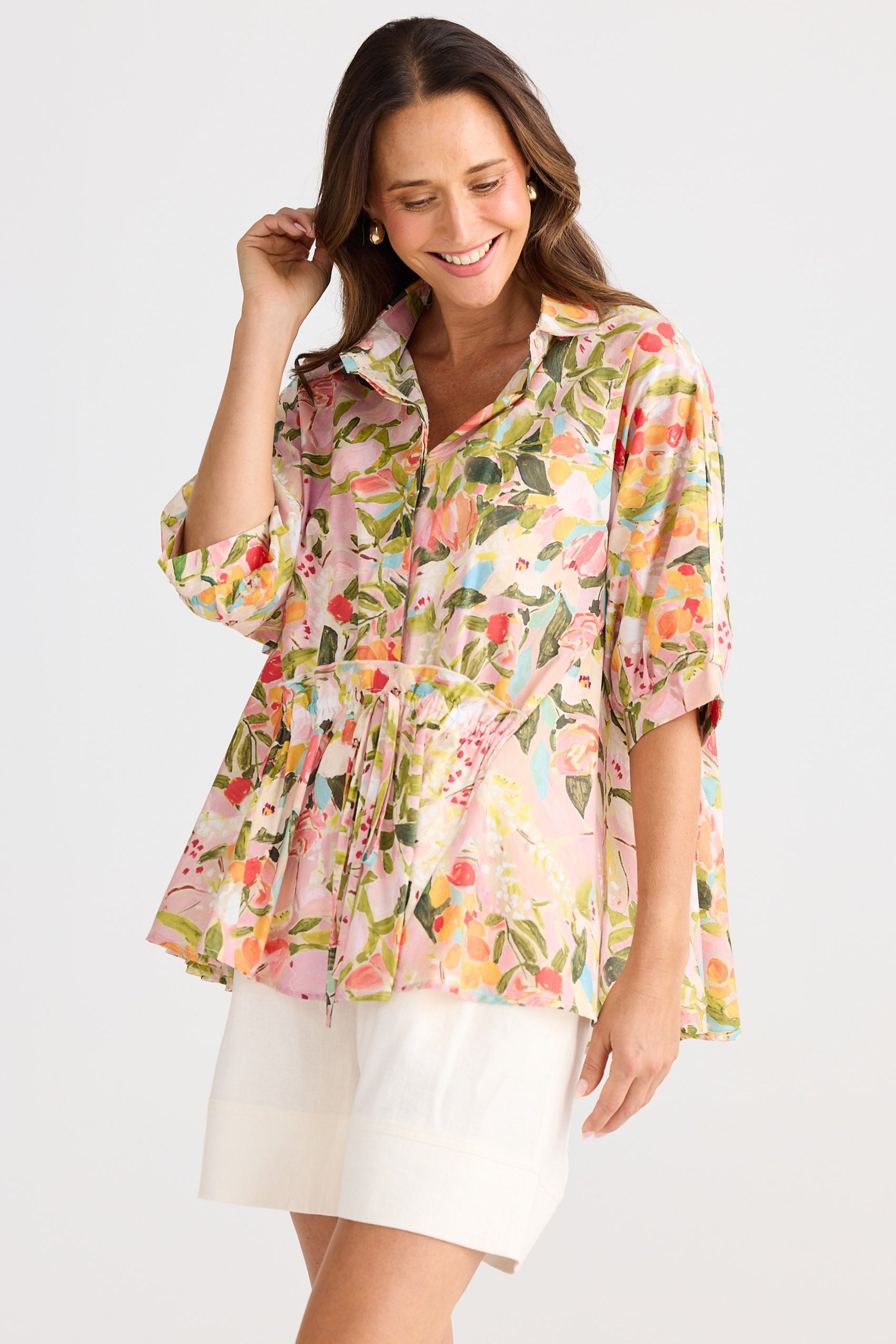 Woman wearing a floral blouse with a white background
