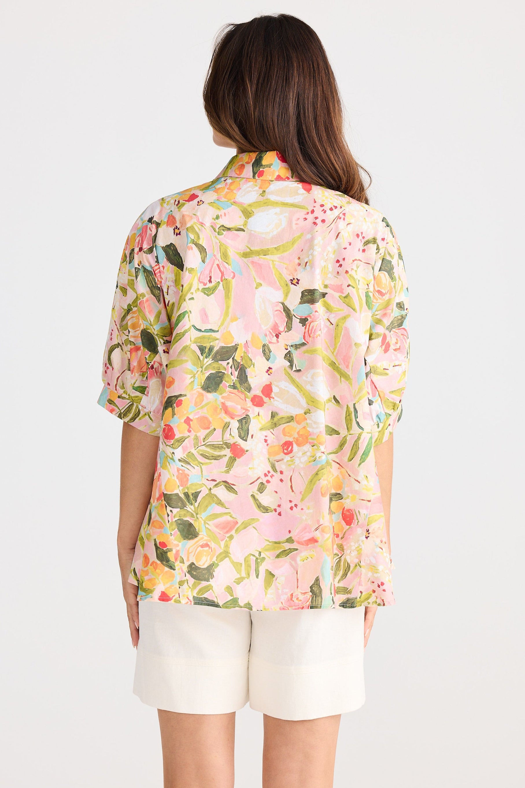 Woman wearing a floral blouse with a white background