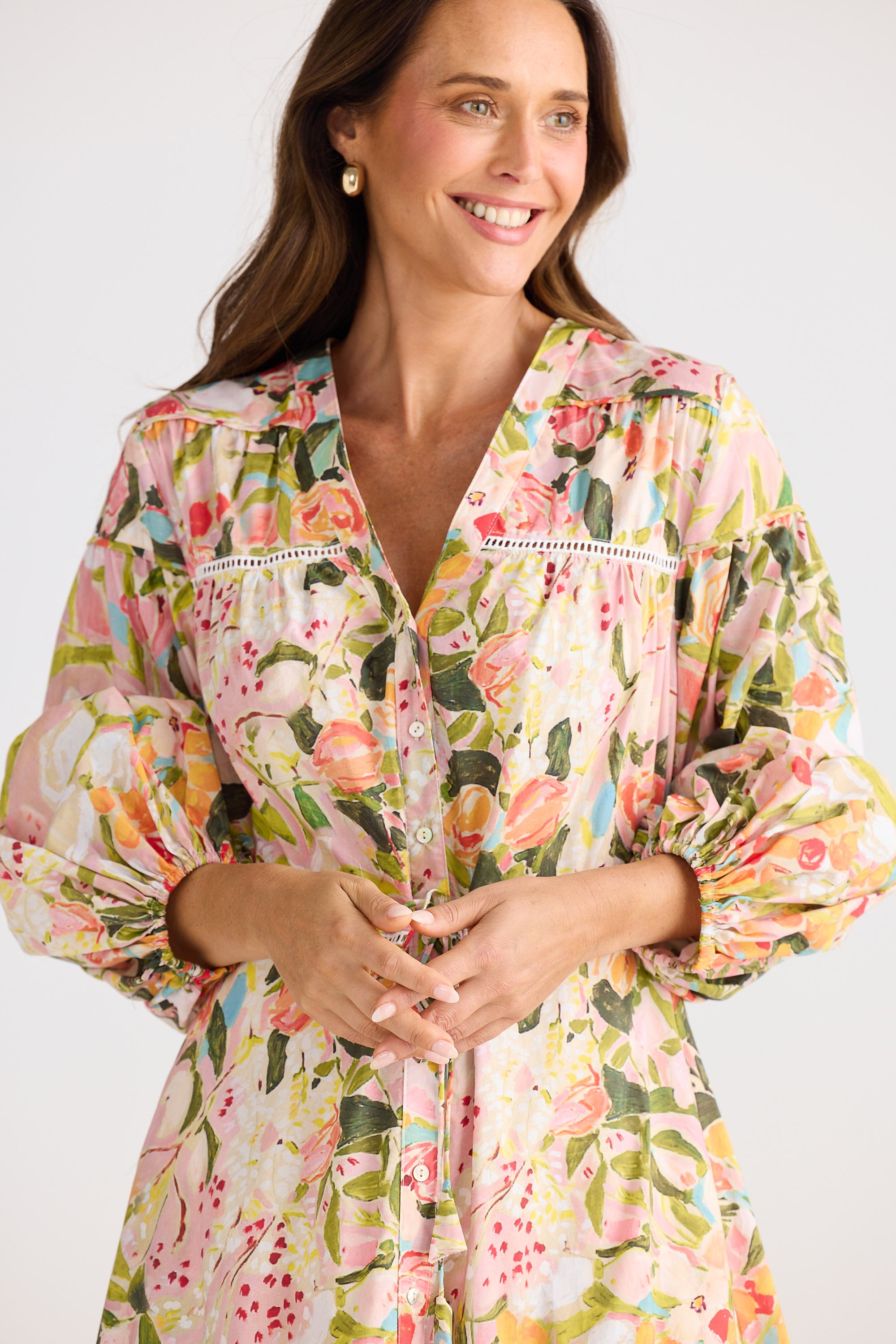 Woman wearing a floral dress with a plain background
