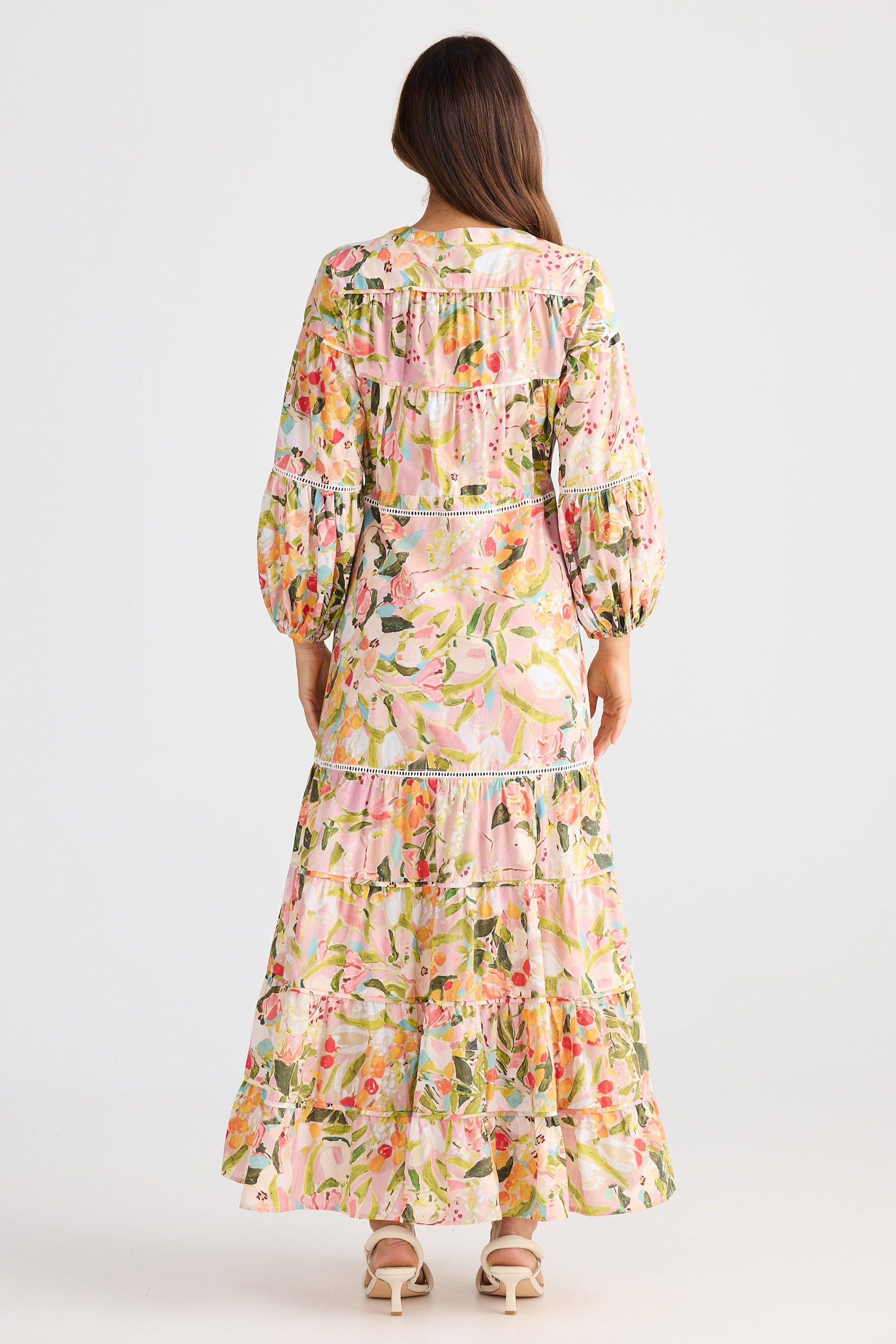 Woman wearing a floral dress on a white background