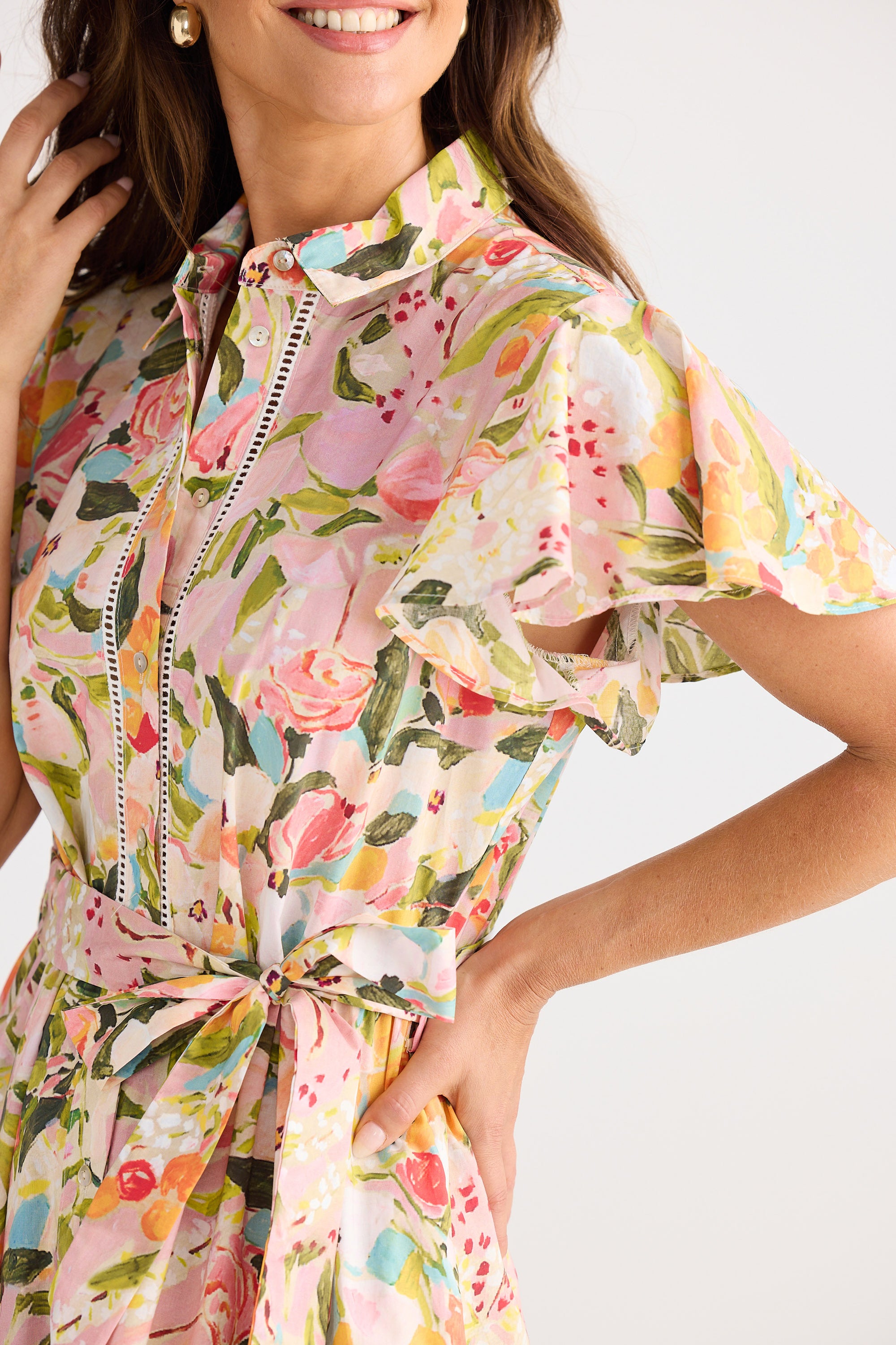 Woman wearing a colorful floral dress on a white background