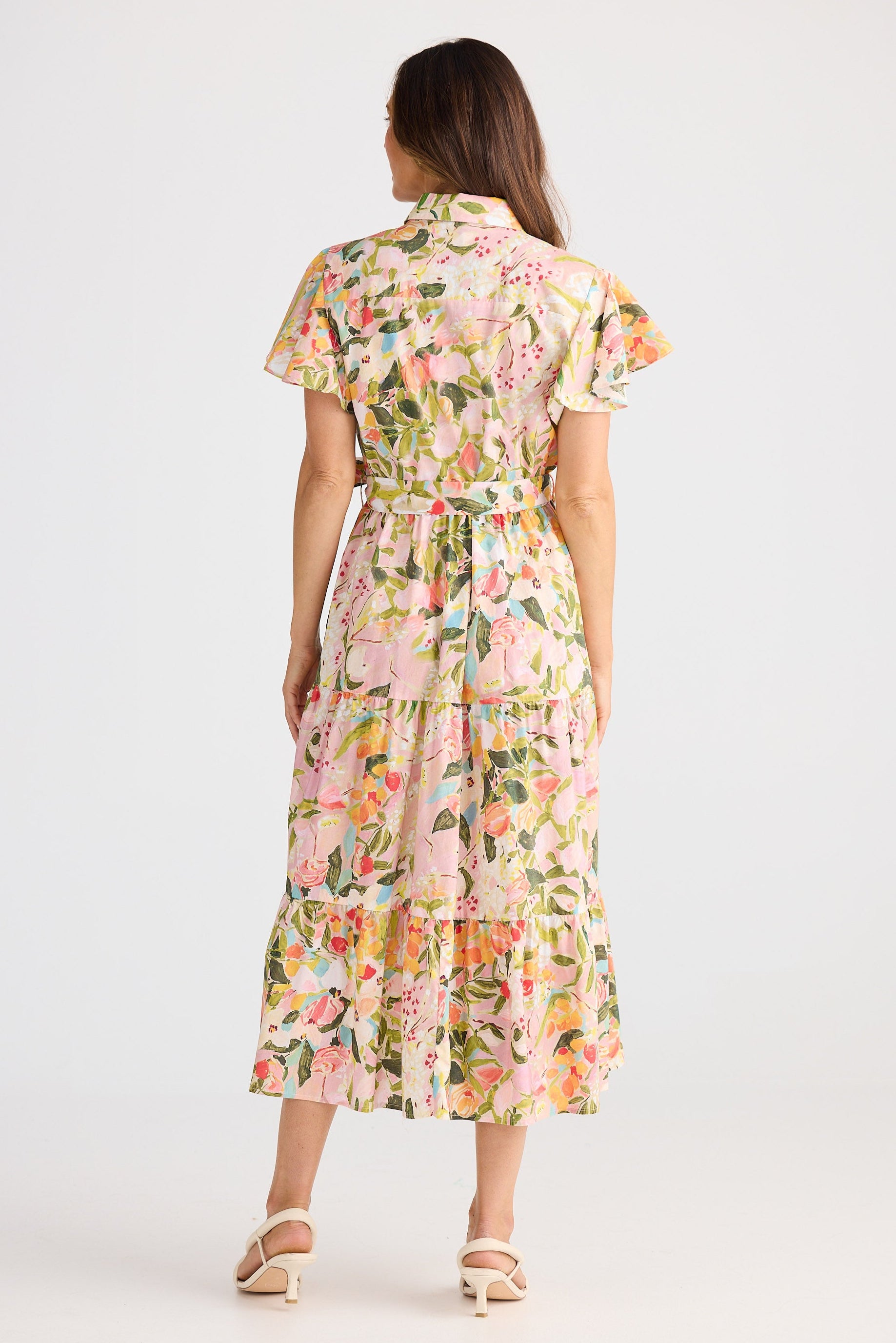 Woman wearing a floral dress on a white background