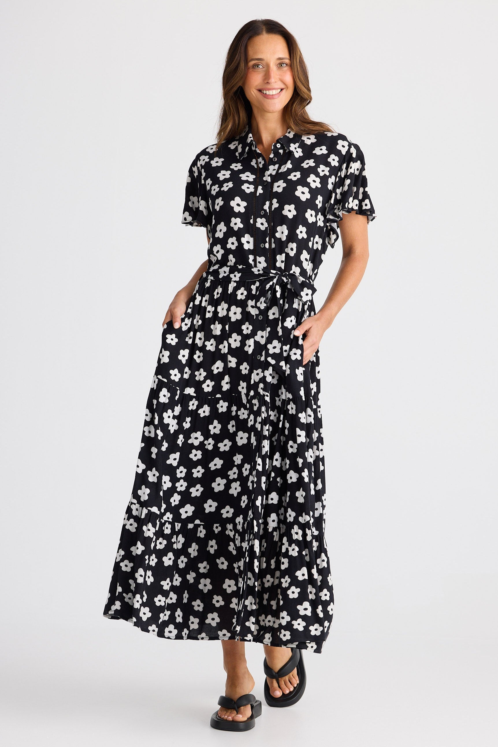 Woman wearing a black floral dress on a white background