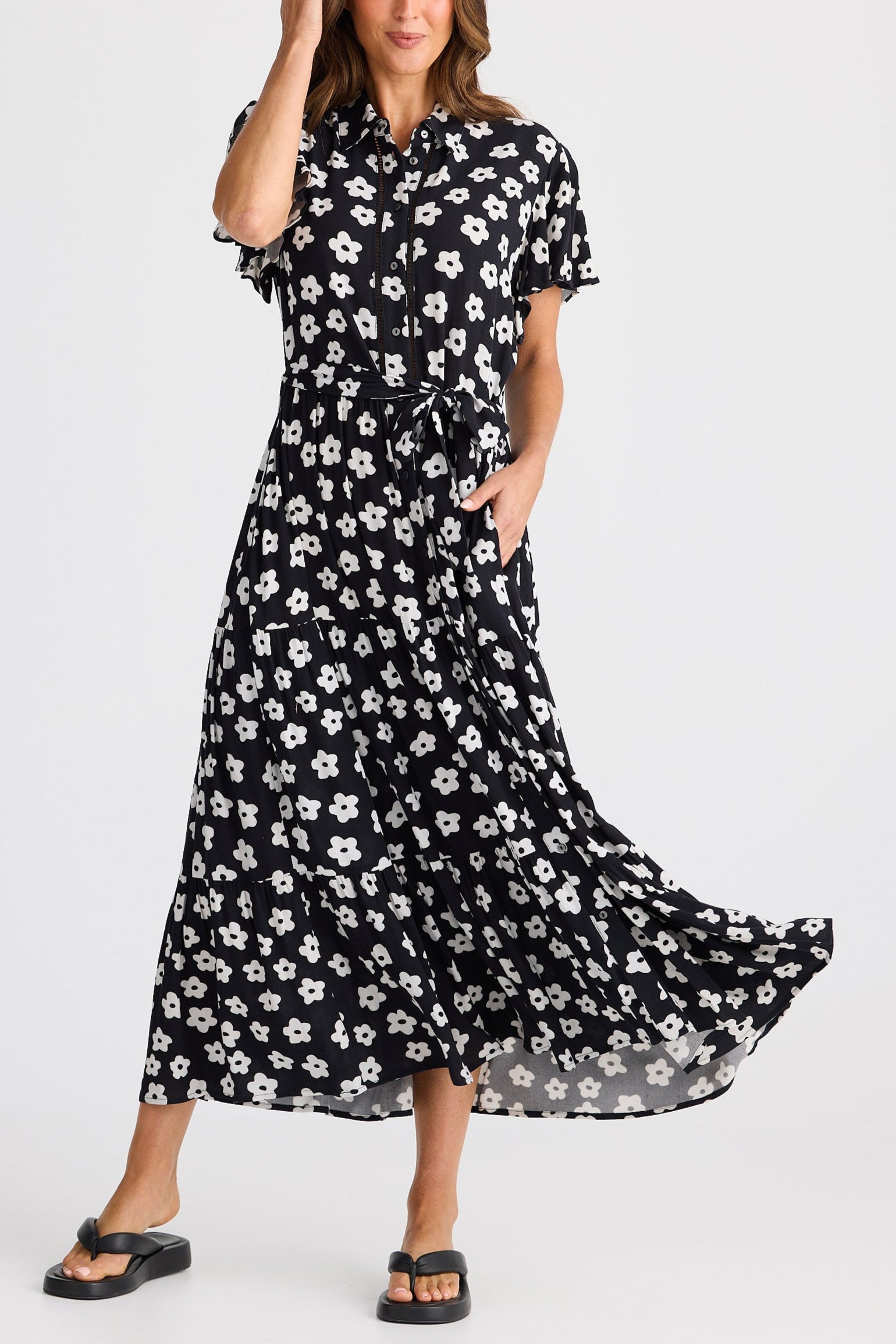 Woman wearing a black floral dress on a white background