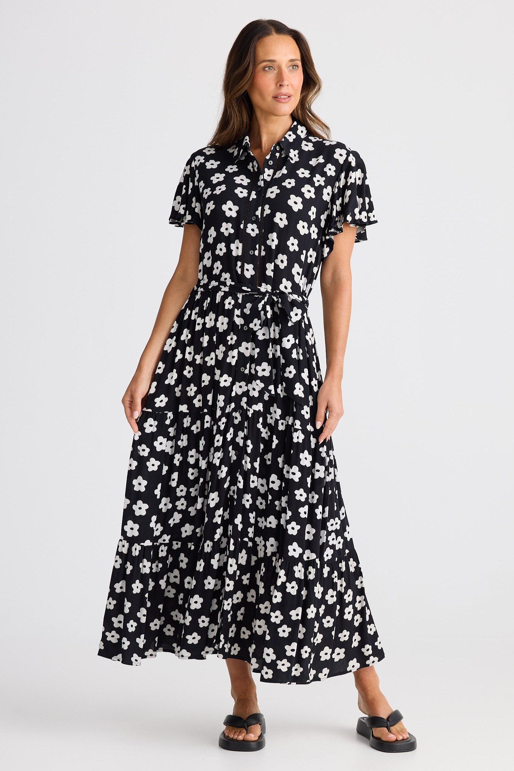 Woman wearing a black floral dress on a white background