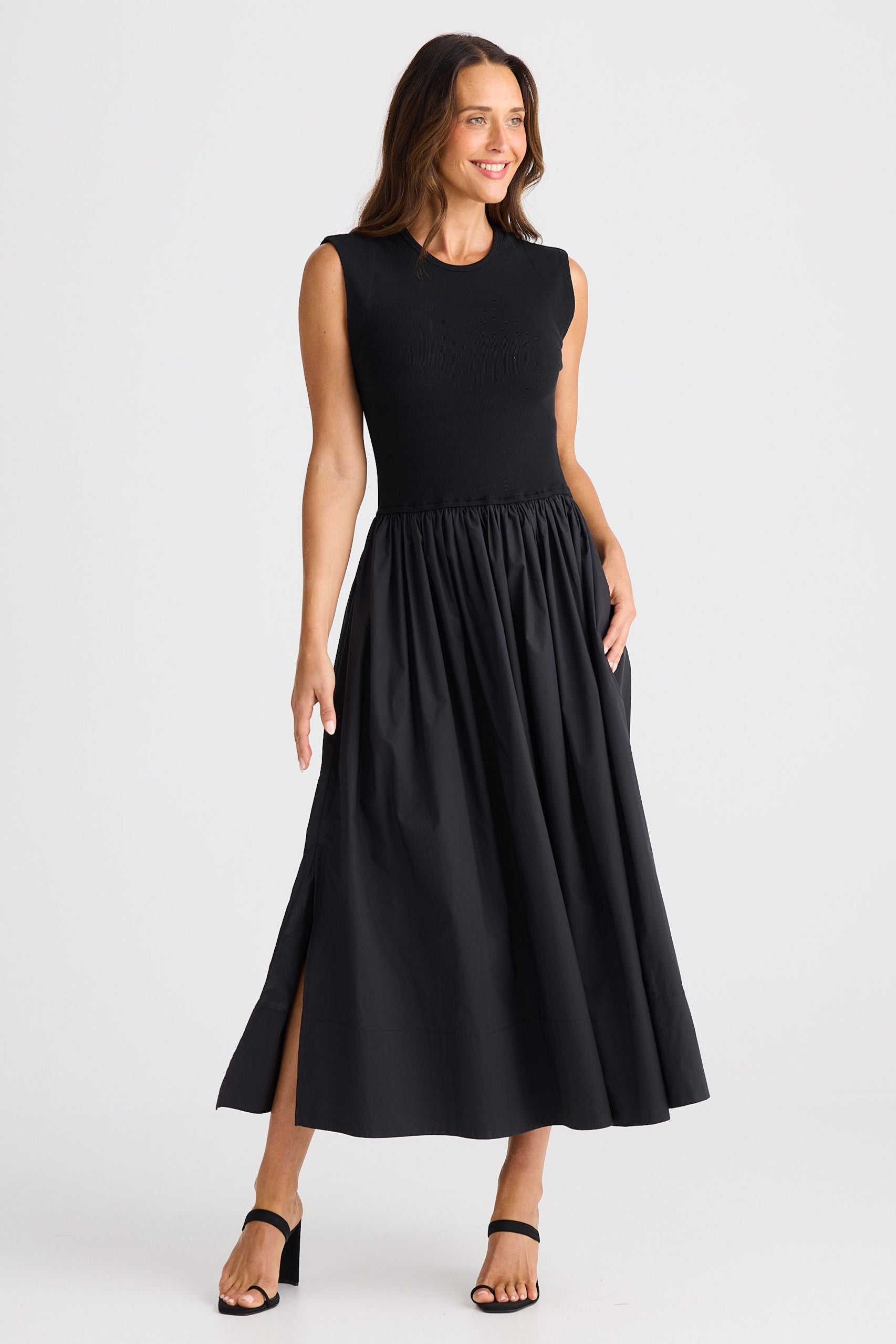 Woman wearing a black sleeveless dress on a white background