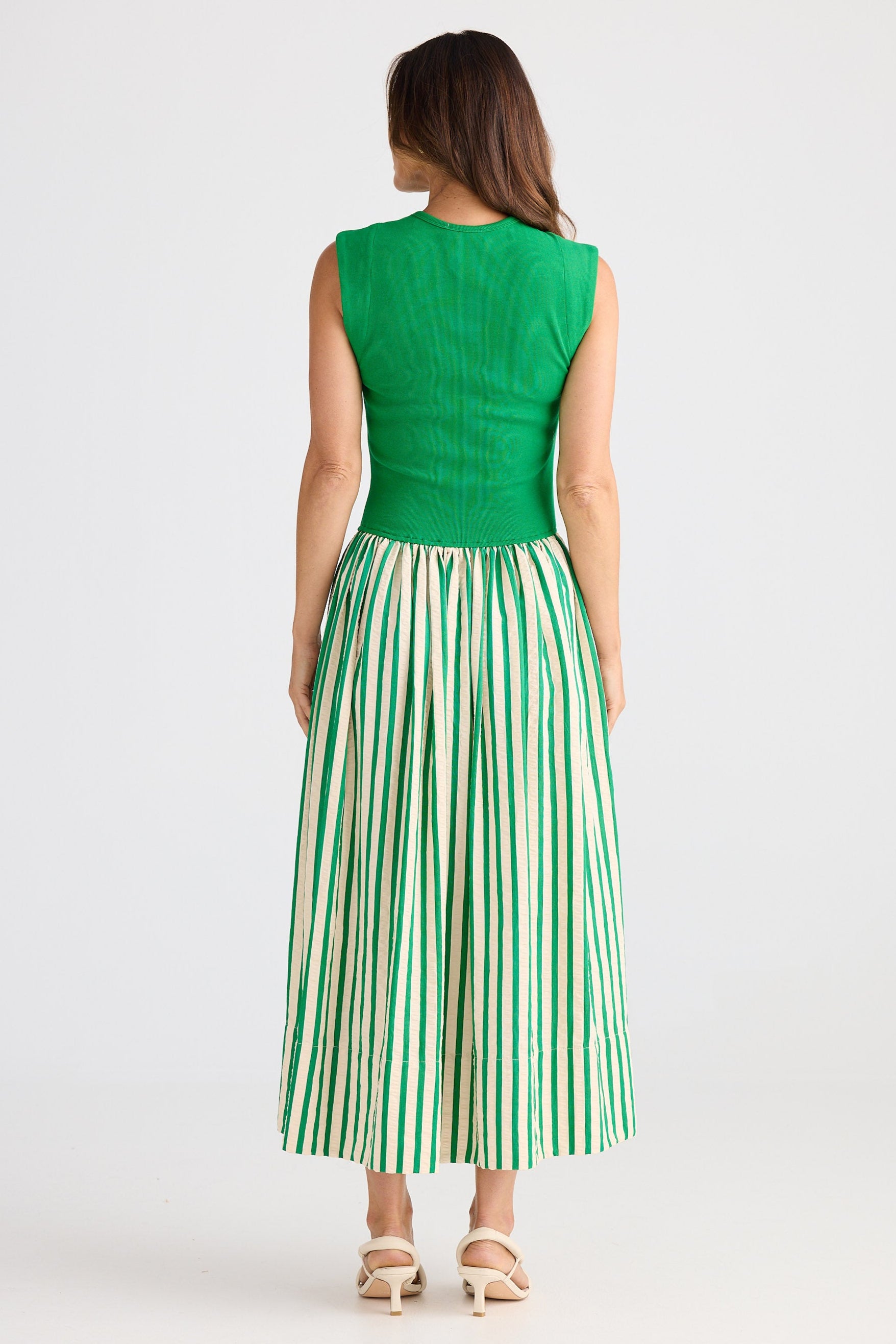 Woman wearing a green dress with a white background