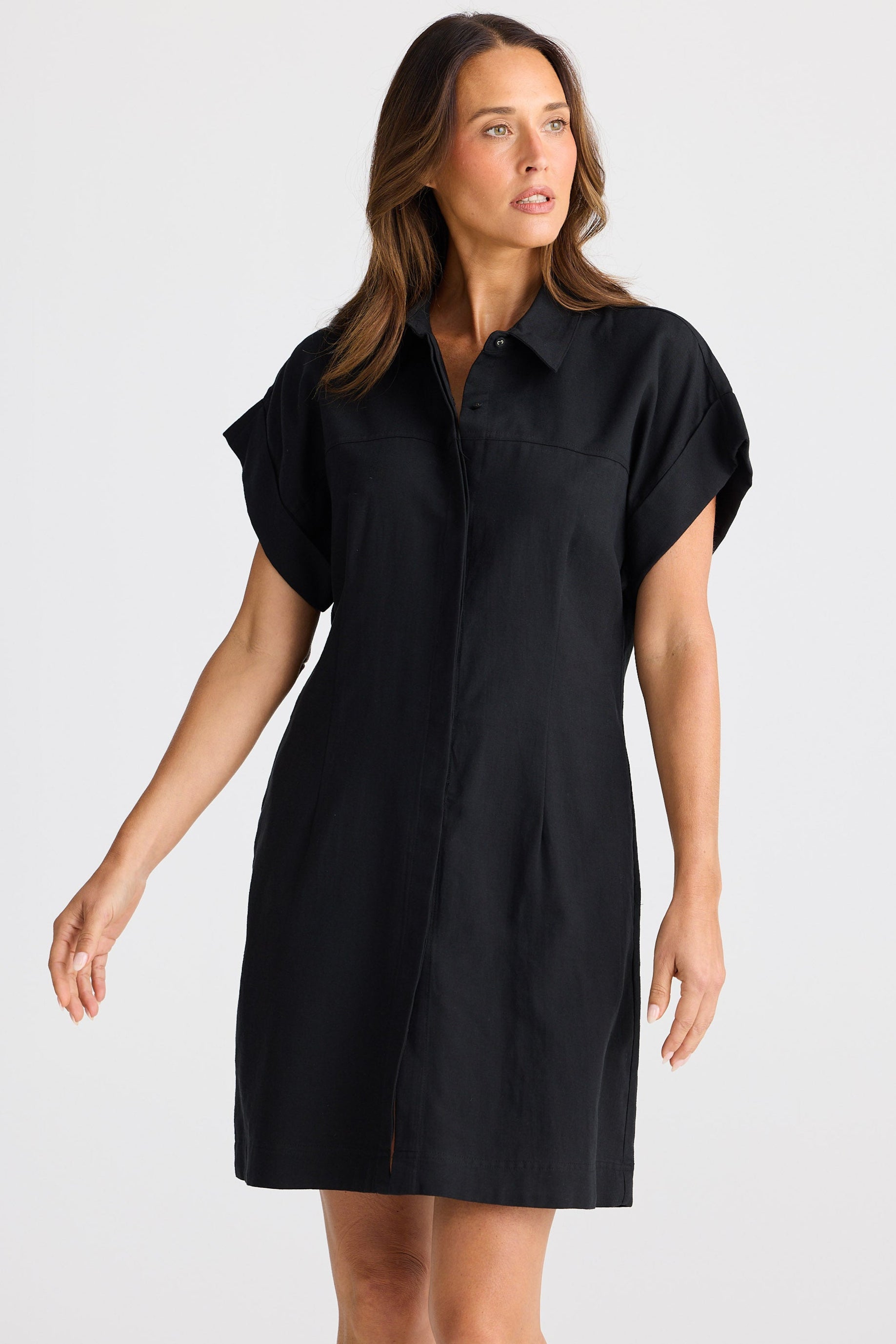 Woman wearing a black dress against a white background