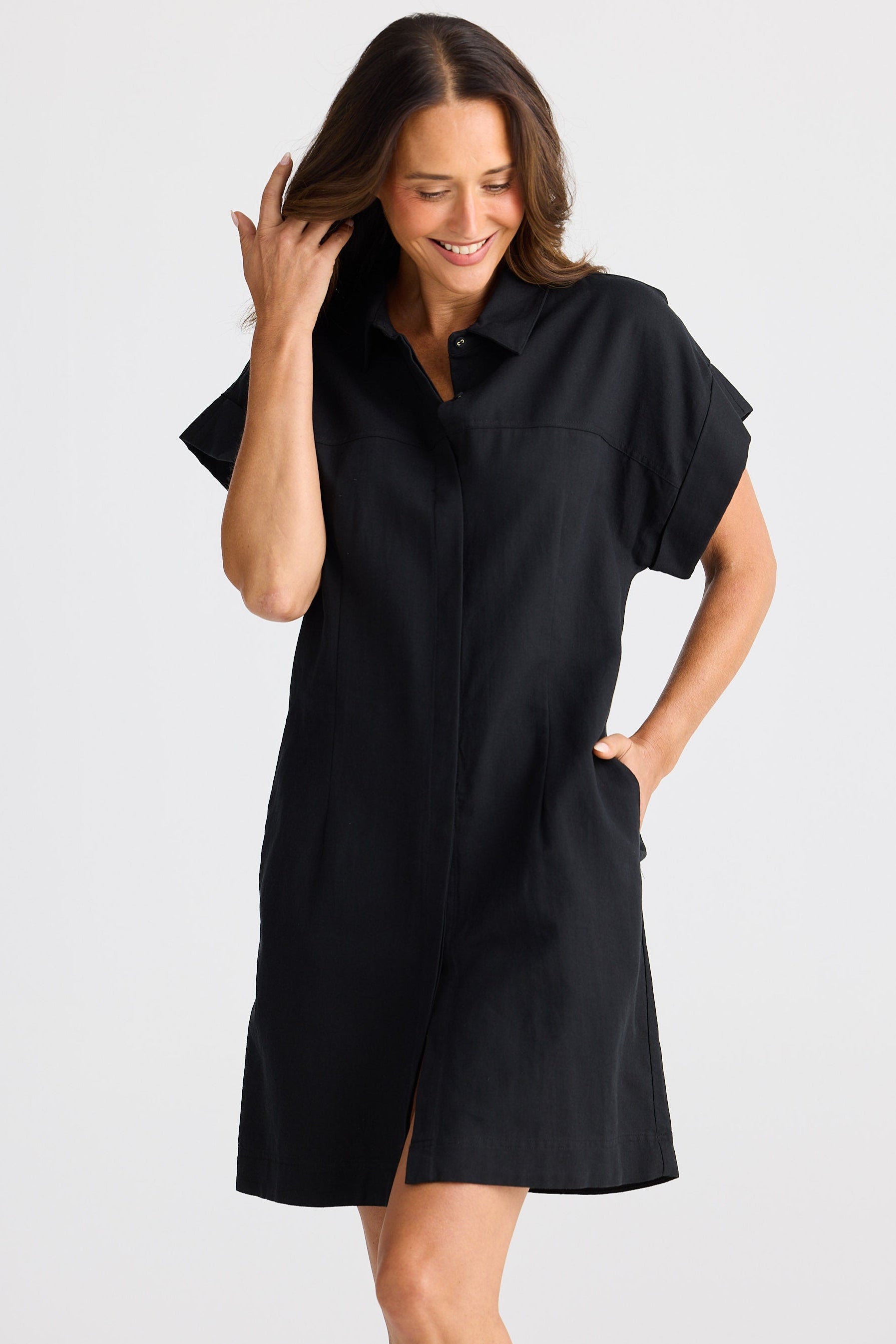 Woman wearing a black dress against a white background