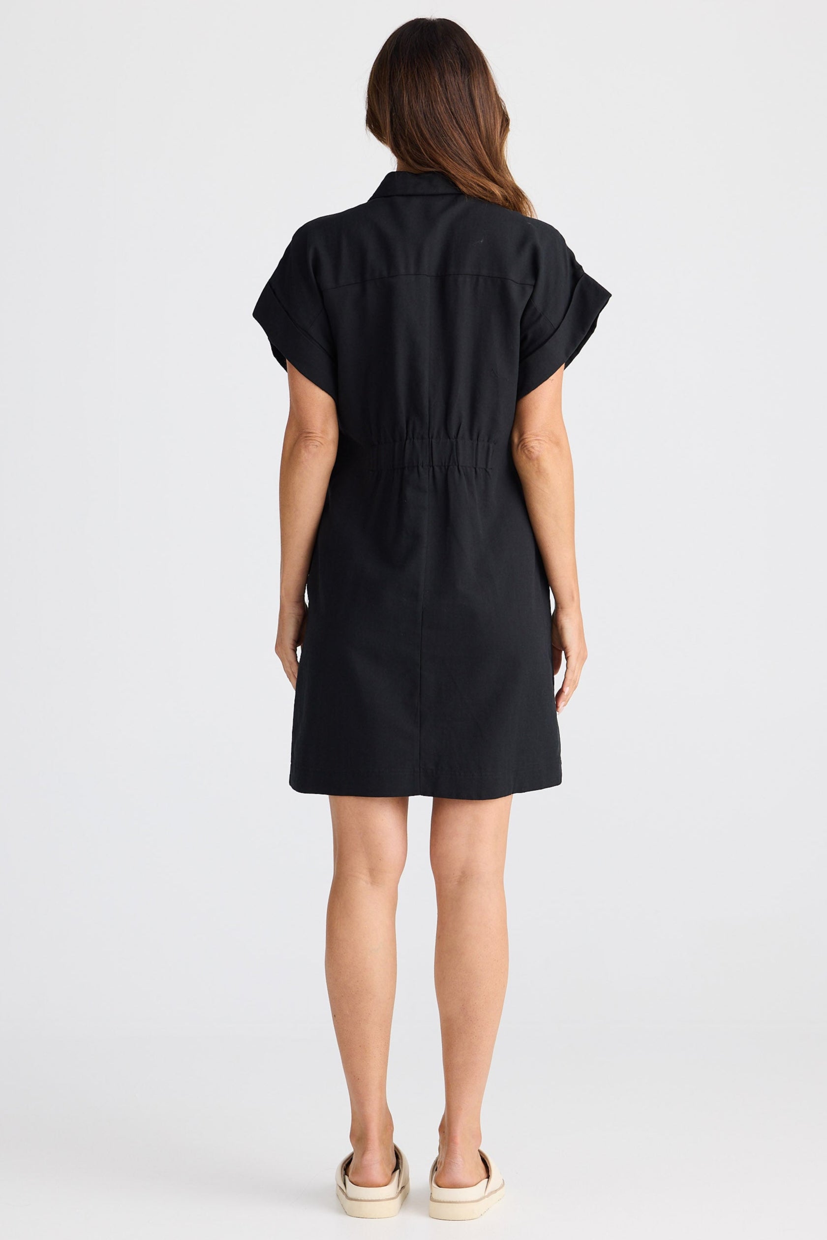 Woman wearing a black dress on a white background