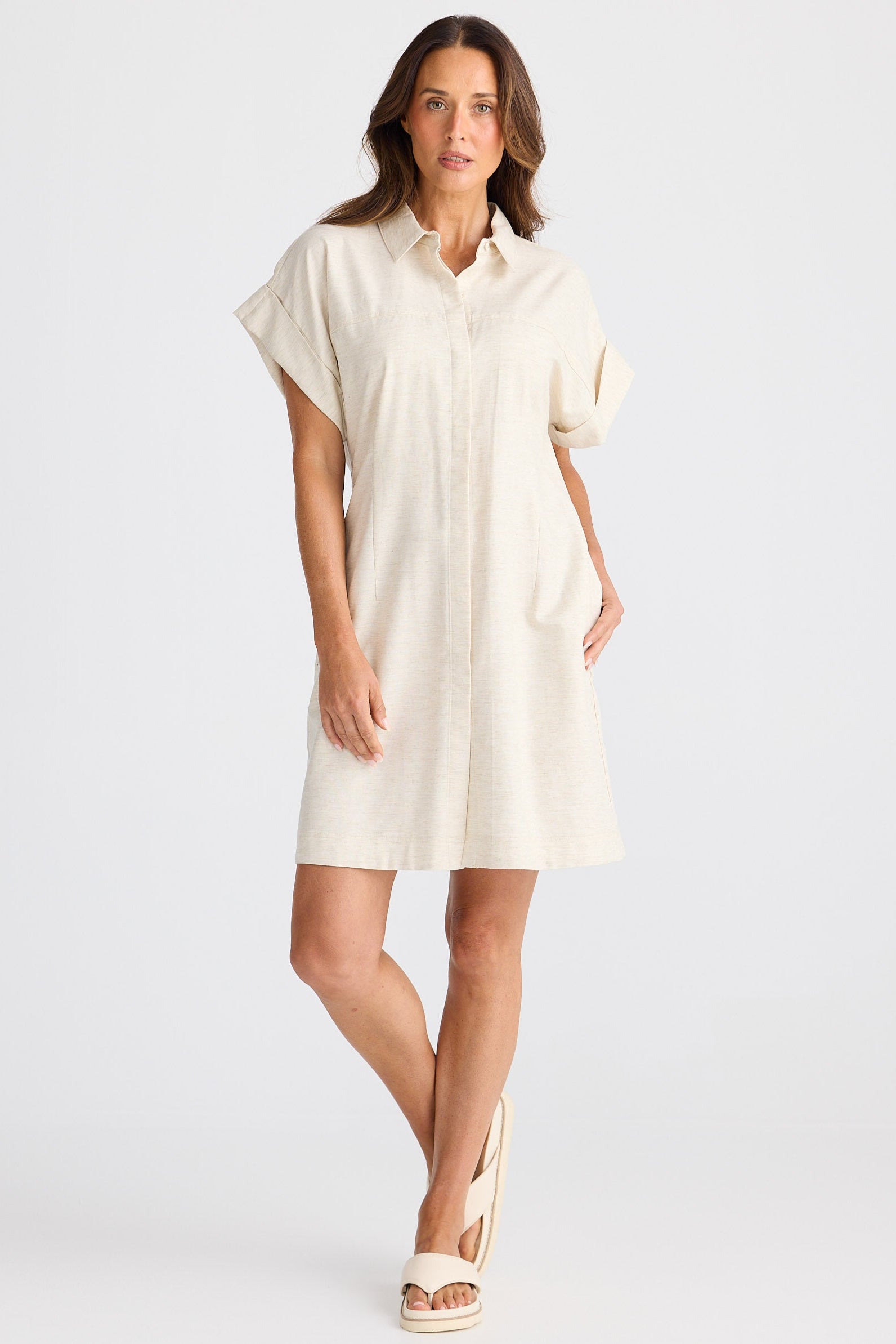 Woman wearing a beige dress on a white background