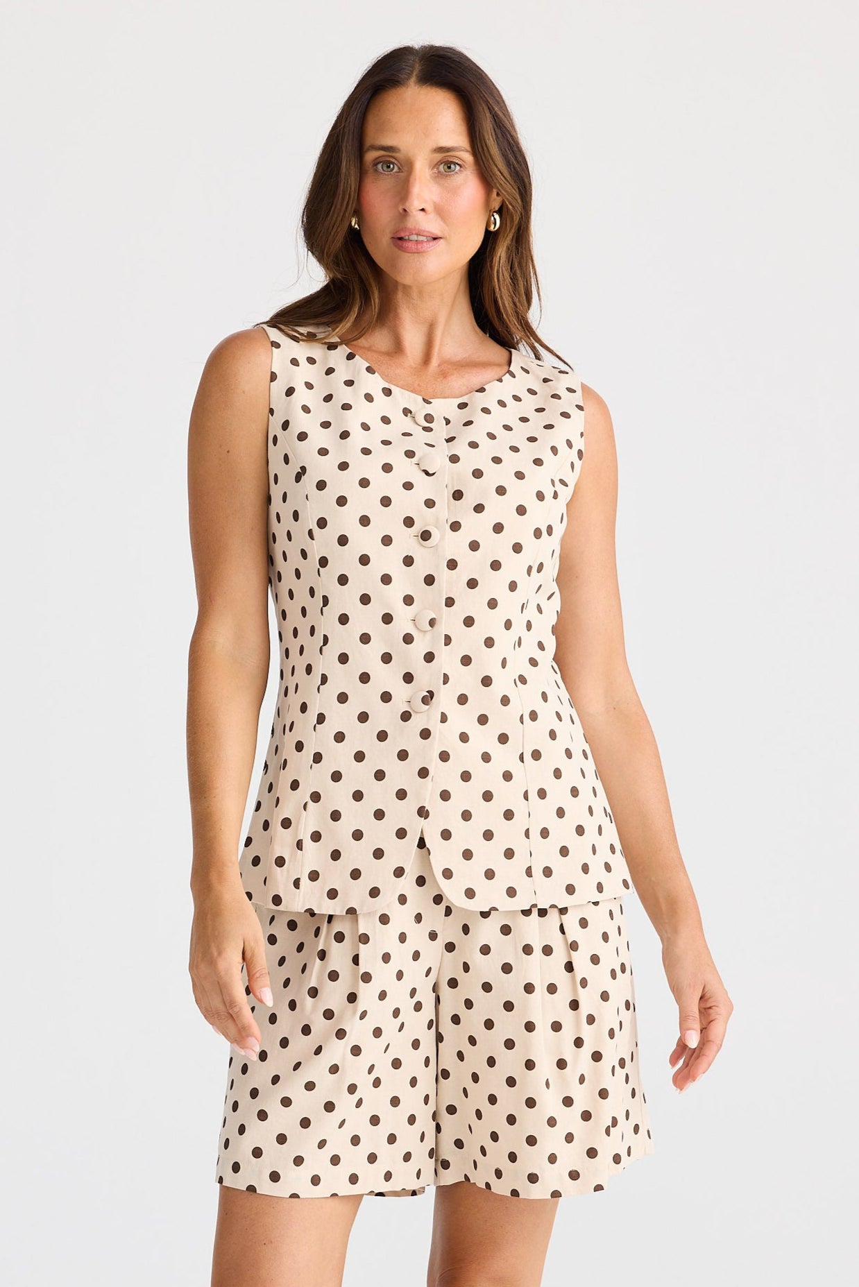 Woman wearing a polka dot dress on a white background