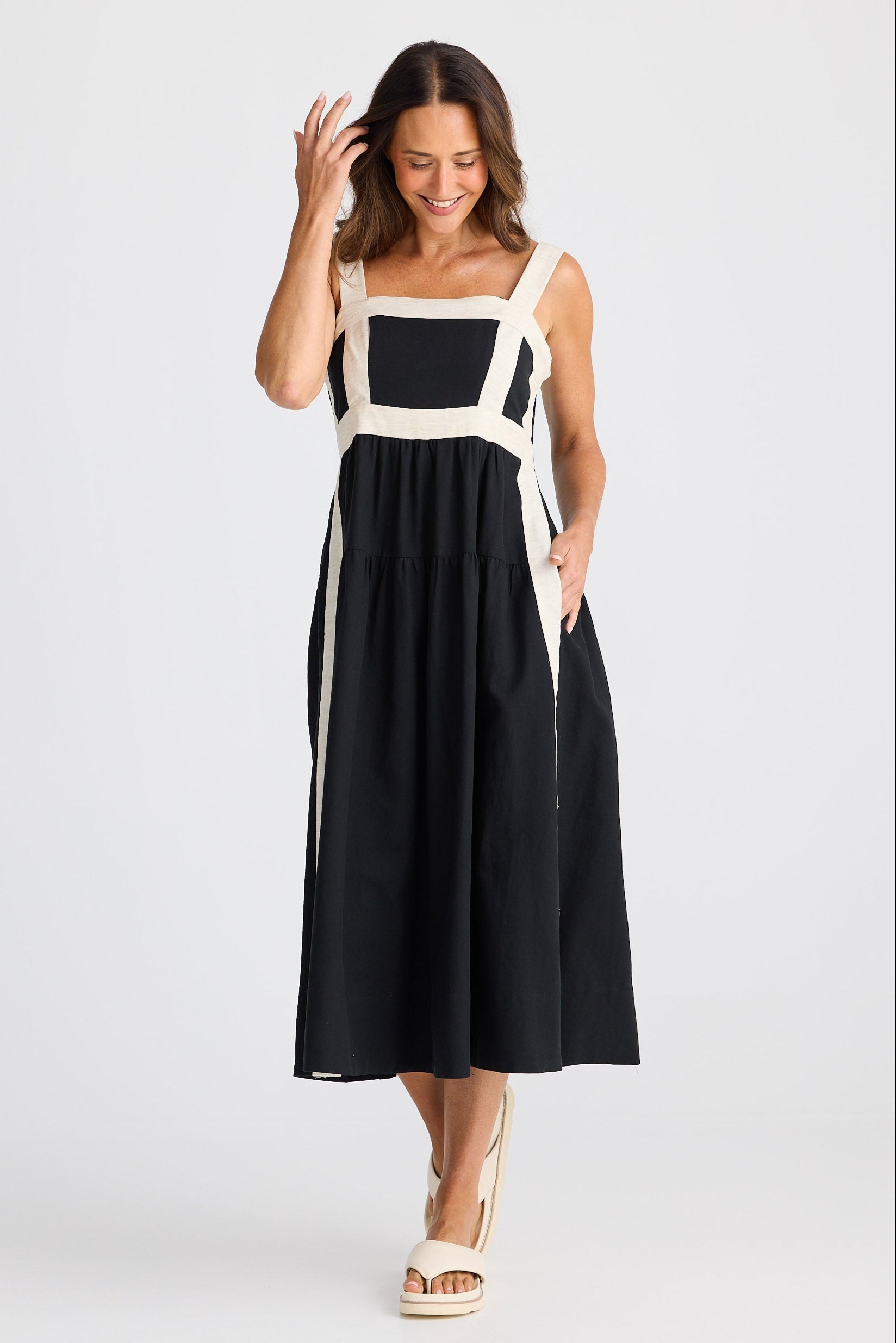 Woman wearing a black and white dress on a white background