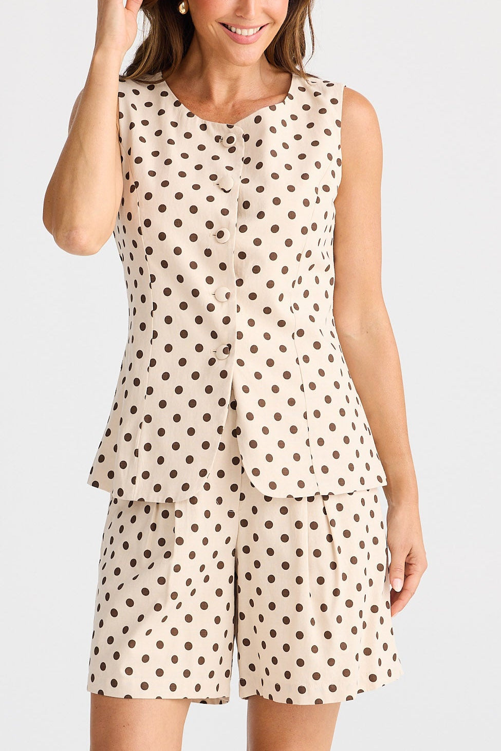 Woman wearing a polka dot dress on a white background