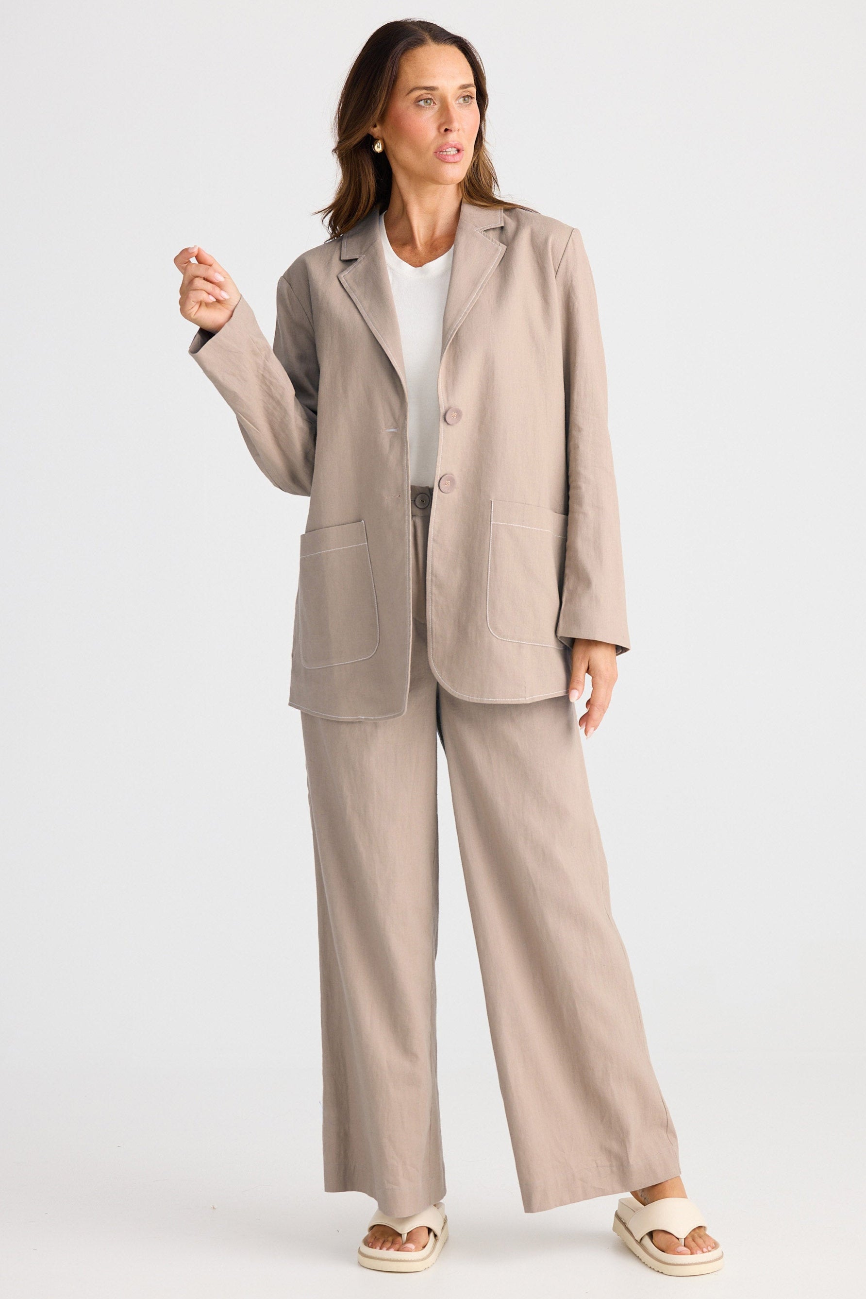 Woman wearing a beige suit on a white background