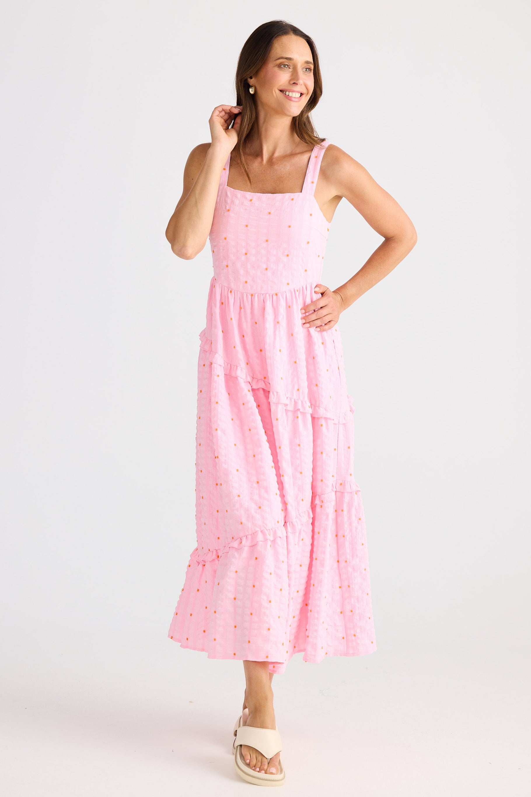 Woman wearing a pink dress on a white background