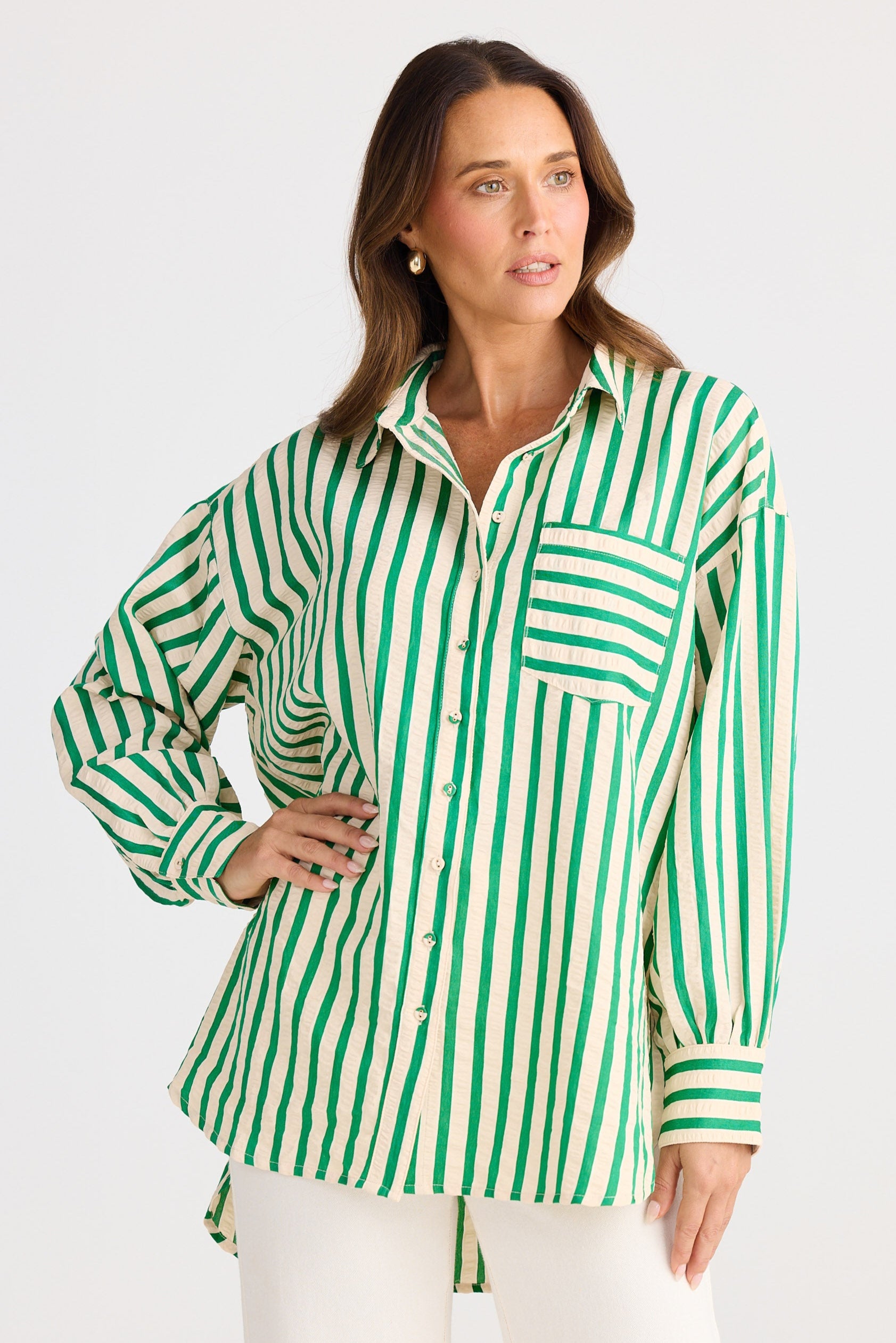 Woman wearing a green and white striped shirt on a white background