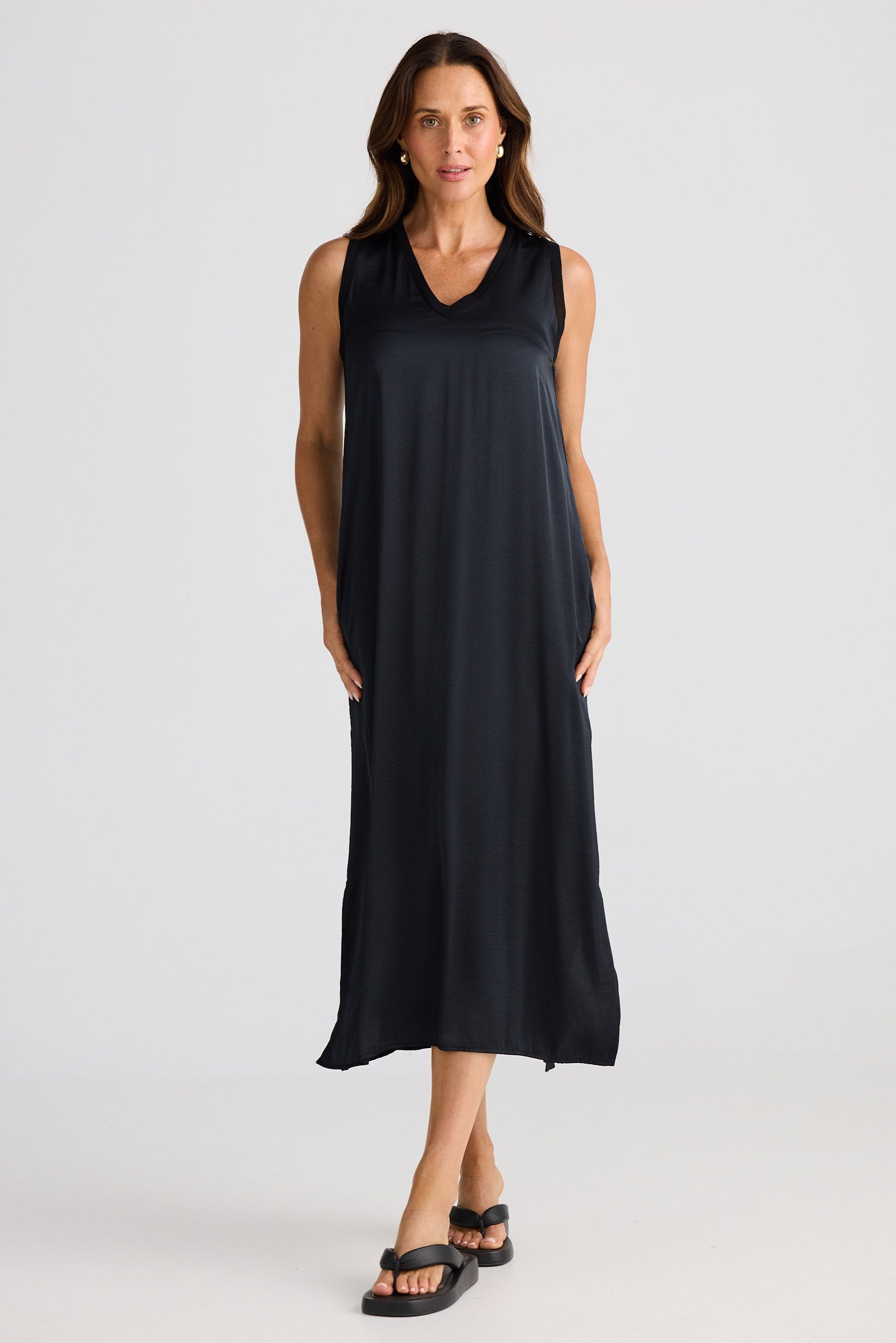 Woman wearing a black sleeveless dress on a white background