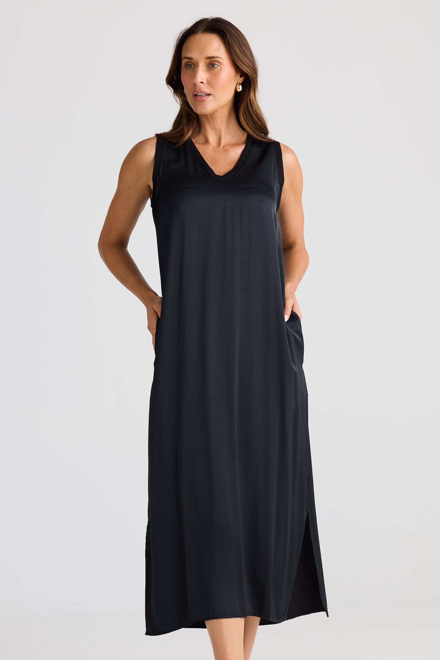 Woman wearing a black sleeveless dress on a white background