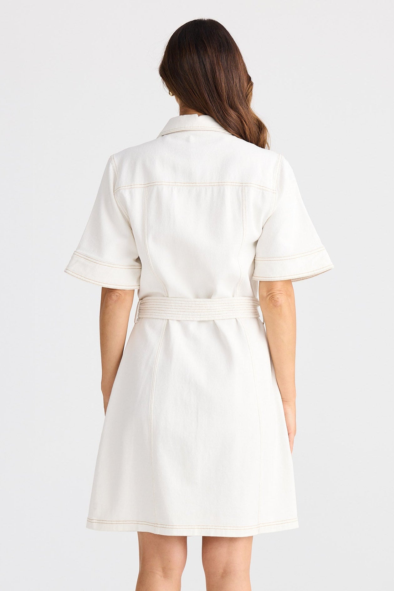 Woman wearing a white dress on a white background