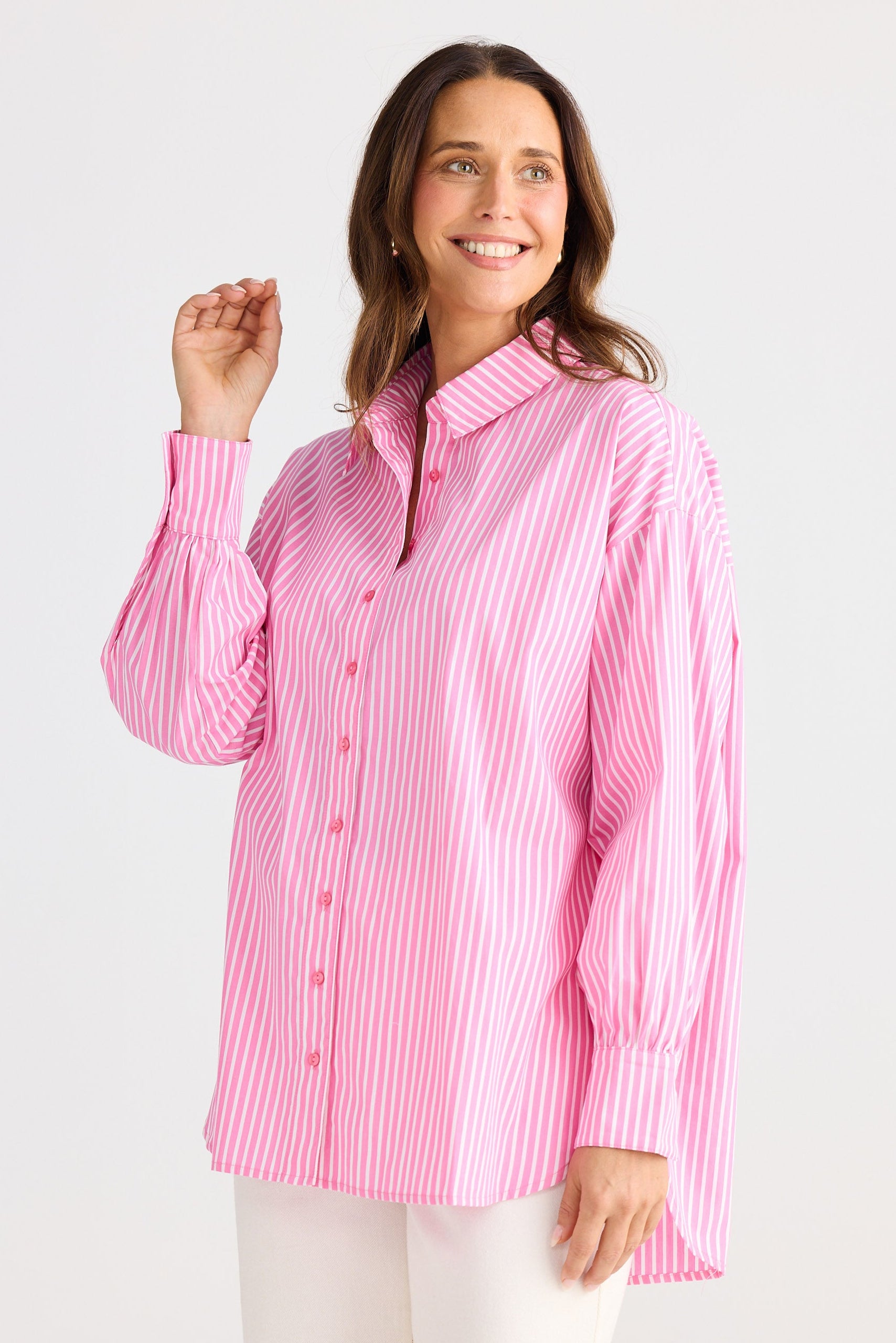 Woman wearing a pink and white striped shirt on a white background